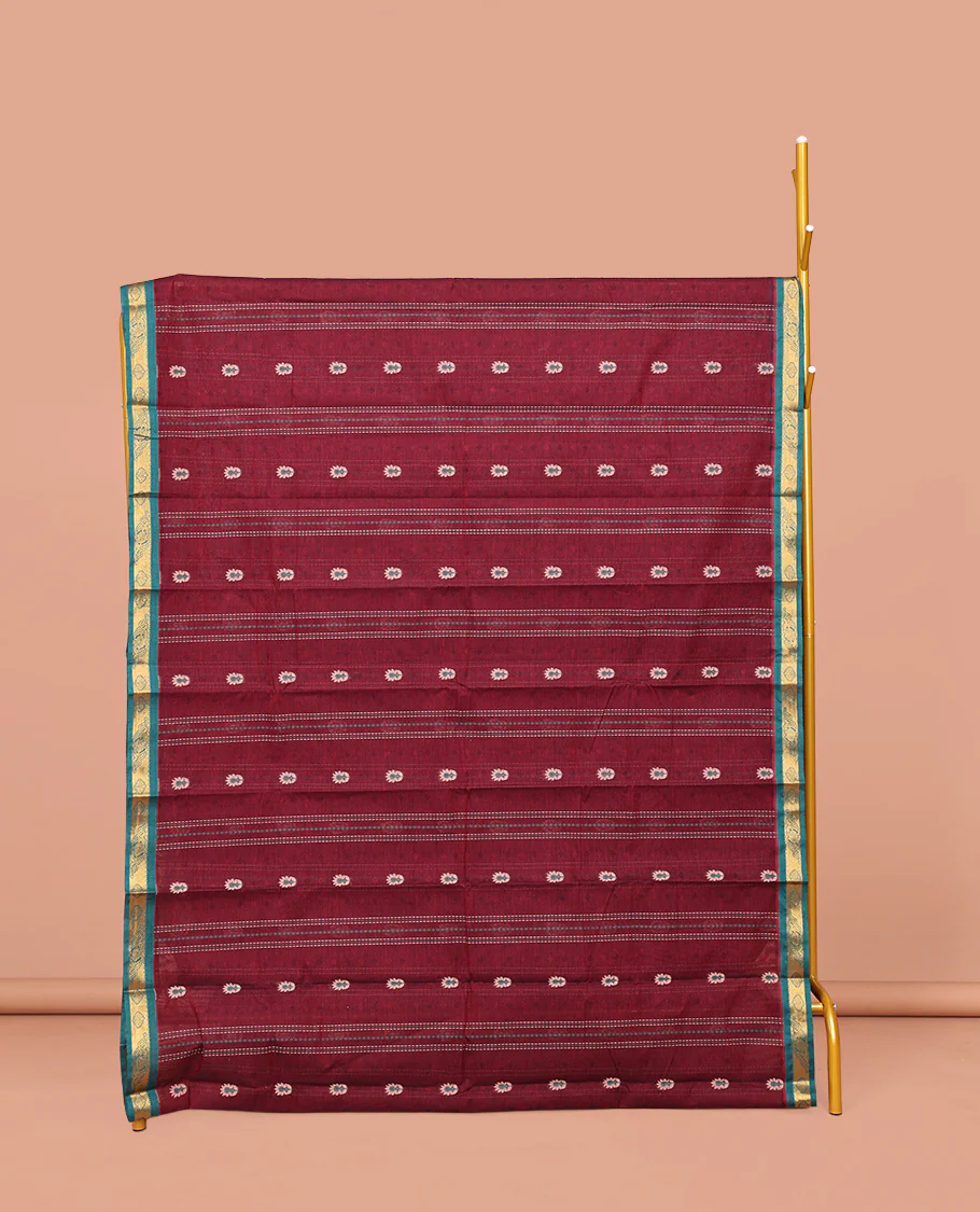 Maroon Kanchi Cotton Saree, Adorned with Buttas and Stripes on Its Body, Complemented by Contrast Zari Border, a Pallu of Jaal Designs, and Paired with a Matching Blouse