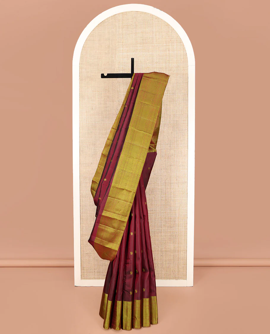 Maroon Kanchipuram Silk Saree, Delicately Woven with Mayil and Chakram Thread Buttas, Complemented by a Contrast Border of Rekku, Kamalam, Poun, Chakram, Kuyil Kann, and Then Kuli Kann Designs, Jaal Design Pallu, and Paired with a Contrast Blouse