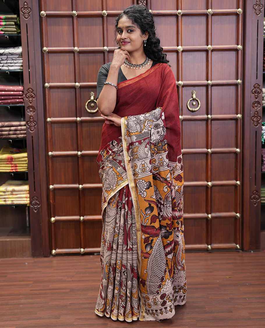 Maroon Kota Cotton Saree, Artfully Decked Up with Kalamkari-Style Human Figurines Printed on the Body, Subtle Piping Border, Pallu Pictures Kalamkari-Style Flora-Fauna Motifs, and Paired with a Contrast-Printed Blouse - Image 2