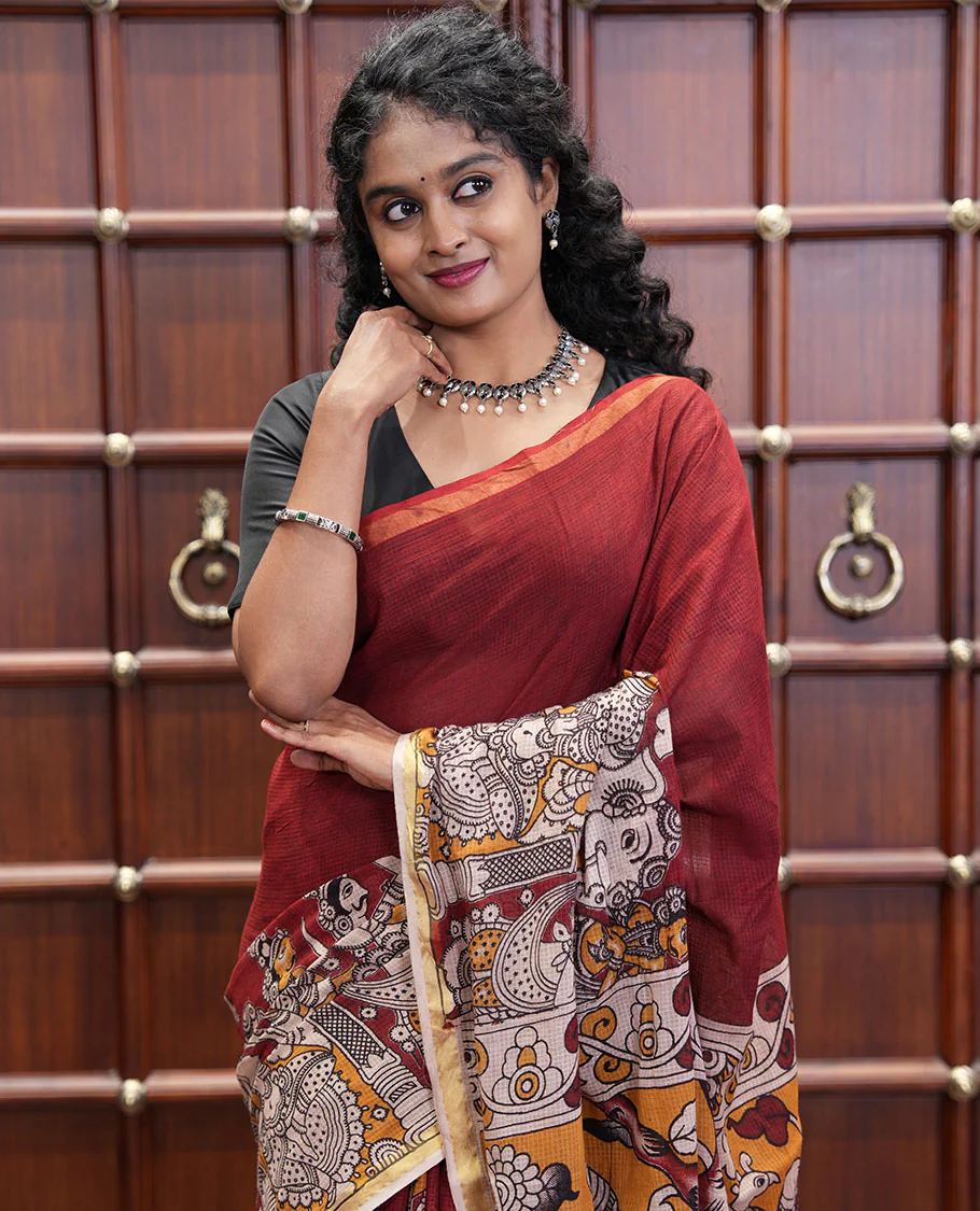Maroon Kota Cotton Saree, Artfully Decked Up with Kalamkari-Style Human Figurines Printed on the Body, Subtle Piping Border, Pallu Pictures Kalamkari-Style Flora-Fauna Motifs, and Paired with a Contrast-Printed Blouse - Image 3