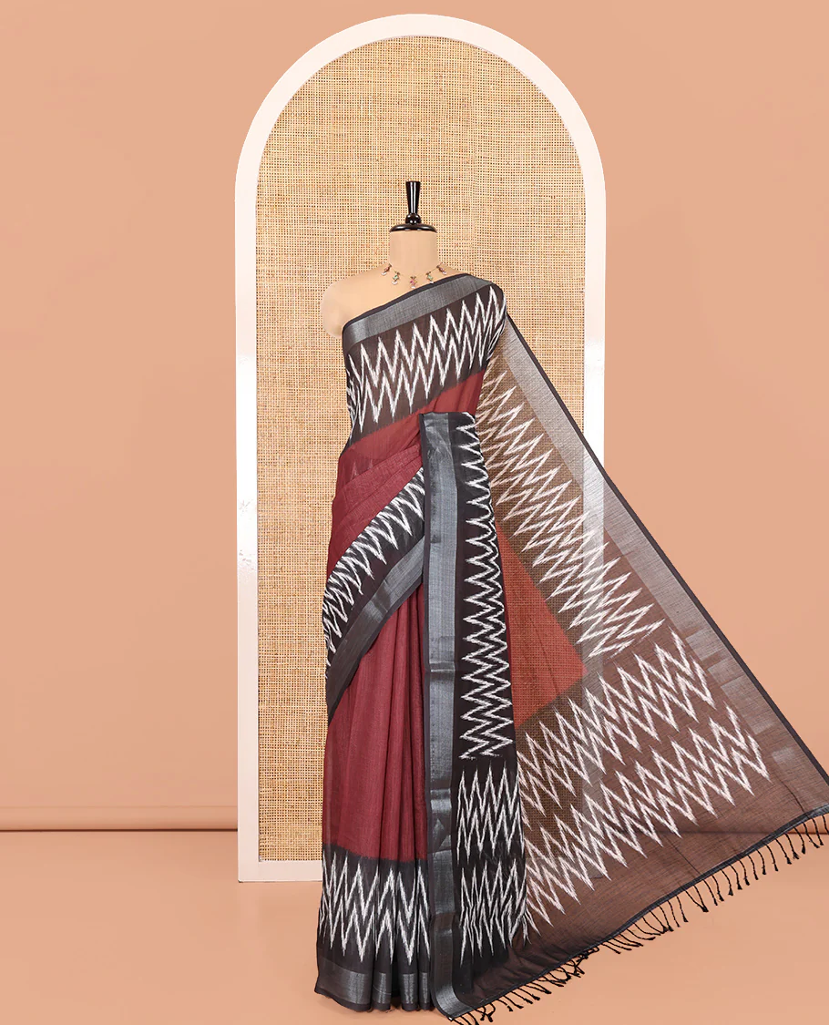 Maroon Plain Linen Cotton Saree, Complemented by a Contrast Ikkat-Style Chevron Striped Border, Chevron Design Pallu, and Paired with a Contrast Blouse