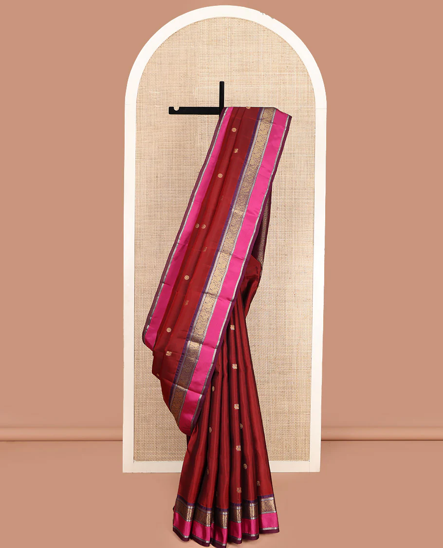 Maroon Vasundhara Lite Silk Mix Saree, Accentuated with Annam Chakram Zari Buttas, Complemented by a Contrast Rettai Pettu Border of Rekku, Kathir, and Mayil Designs, Meticulously Designed Pallu, and Paired with a Contrast Blouse