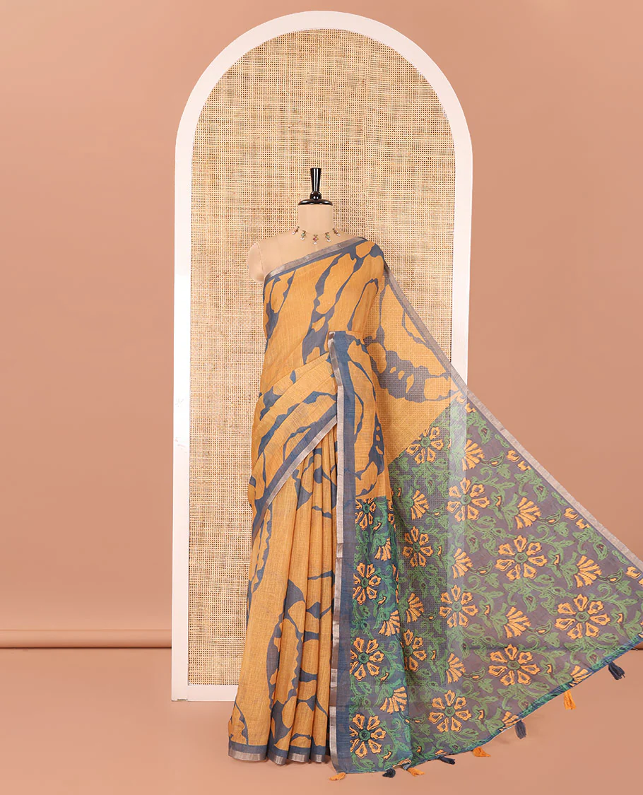 Mustard Linen Cotton Saree, Adorned with Shibori Prints on Its Body, Subtle Contrast Piping Border, Pallu of Floral Print, and Paired with a Matching Blouse