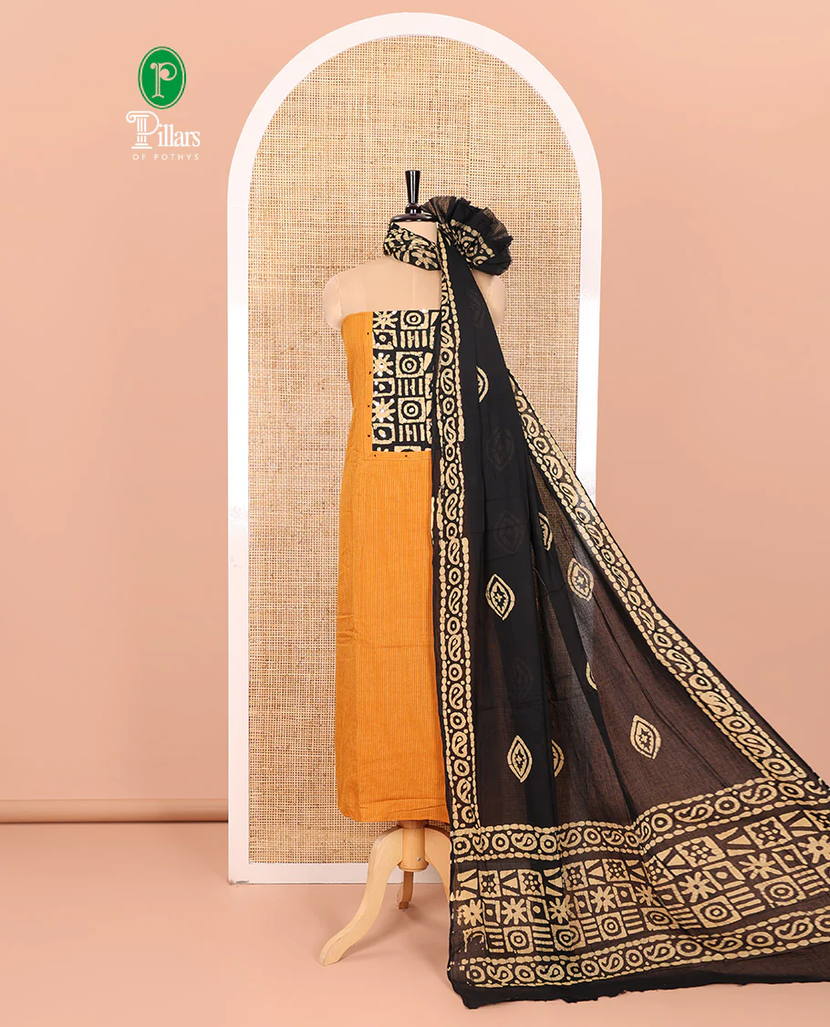 Mustard Material Chudidar Set Beautified with Kantha Embroidery, Batik Print, and Mirror Work on the Cotton Top, Comes with a Batik Geometric Patterns Printed Bottom, and a Cotton Batik Geometric Printed Dupatta