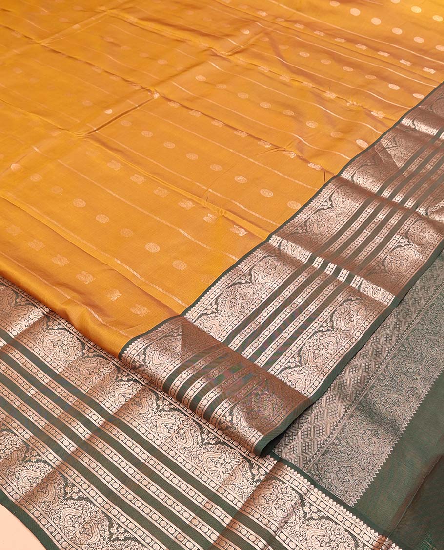 Mustard Vasundhara Lite Silk Mix Saree, Richly Detailed with Zari Buttas and Stripes All Over Its Body Complemented by Contrast Border of Thilakam Mokku, Rudraksham, and Mayil Designs, Grand Jaal Pallu, and Paired with a Contrast Blouse - Image 2