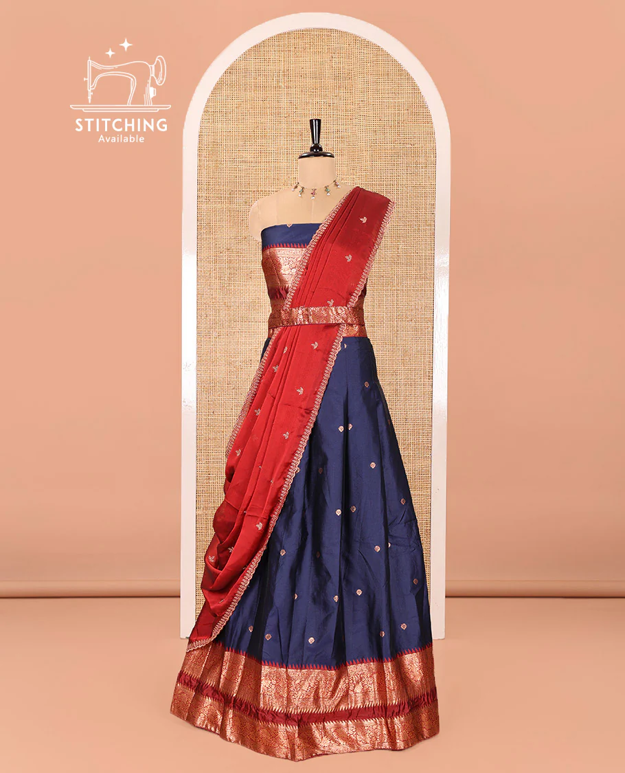 Navy Blue-Red Semi-Banarasi Half-Saree Adorned with Zari Buttas on Its Skirt, Complemented by a Contrast Traditional Zari Temple Rettai Pettu Border, Paired with a Matching Blouse, and a Satin Georgette Embroidered Scallop Dhavani