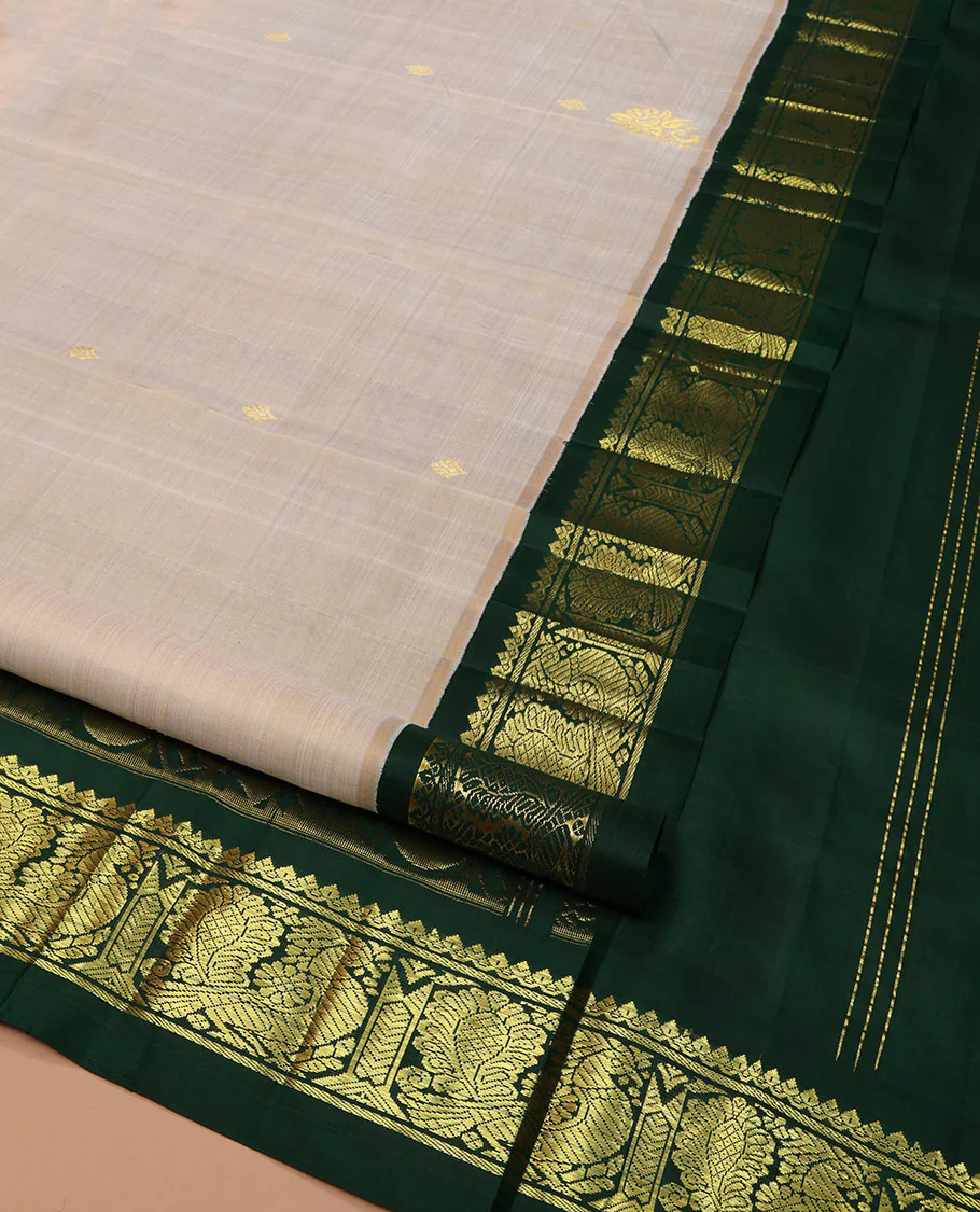 Off-White Kanchipuram Silk Saree, Embellished with Zari Buttas on Its Body, Complemented by a Contrast One-Sided Korvai Border of Salngai, Banaras, and Mayil Designs, Pallu of Floral Zari Designs, and Comes Without a Blouse - Image 2