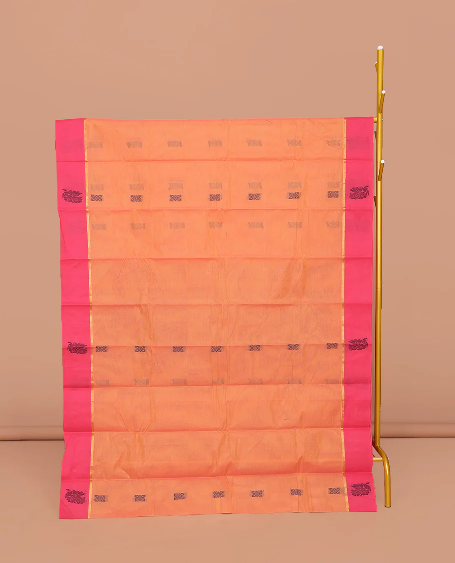 Orange Kanchi Cotton Saree, Decked Up with Buttas All Over Its Body, Complemented by a Contrast Floral  Border, Pallu of Floral Designs, and Paired with a Matching Blouse