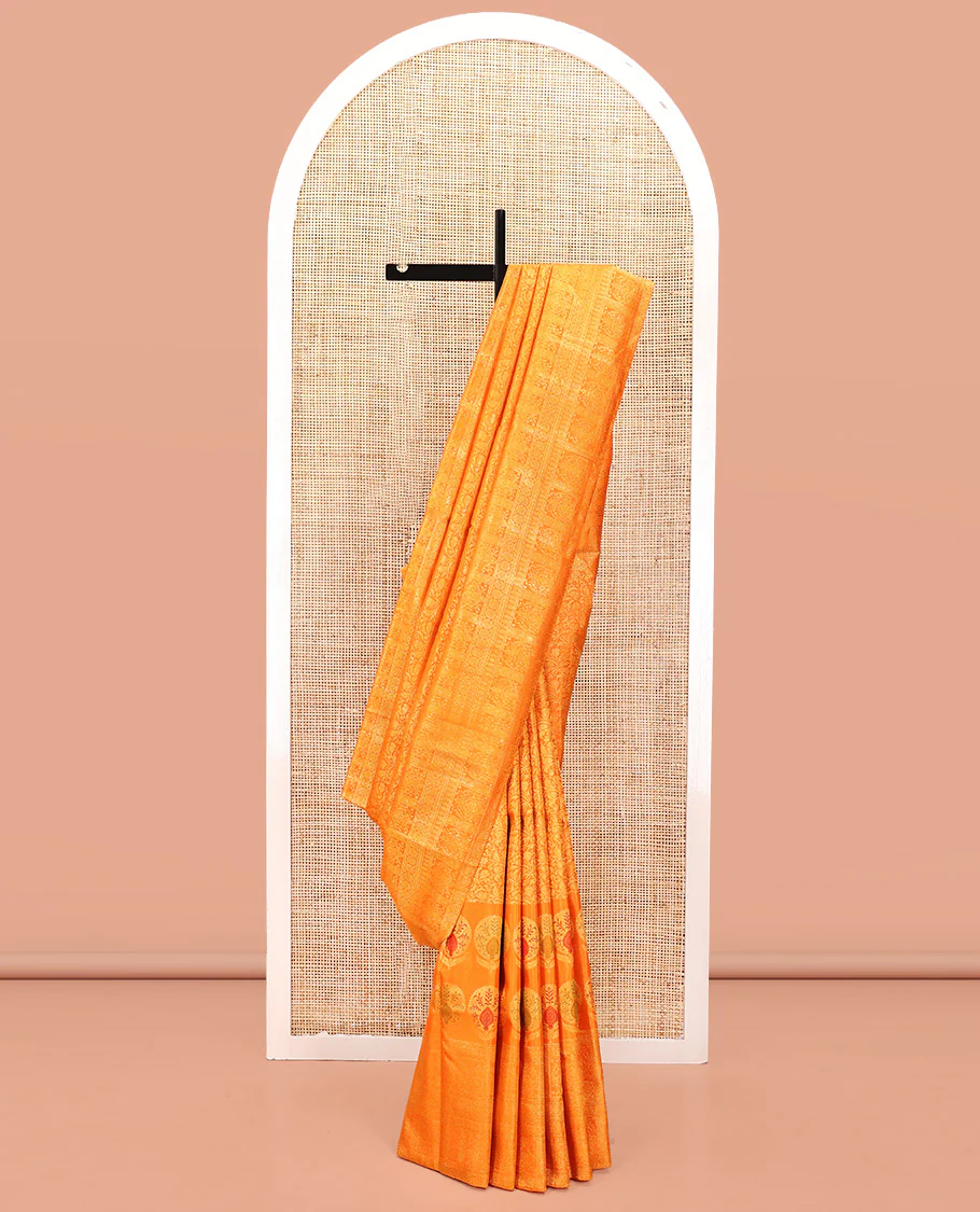 Orange Kanchipuram Designer Silk Saree, Subtly Sparkled With Floral Jacquard Design On Its Body, Highlighted by Meenakari Mughal Intricate Border, Intricate Pallu and Paired with a Matching Blouse