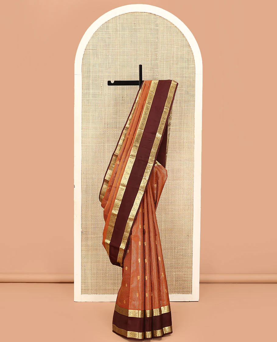 Orange Vasundhara Lite Silk Mix Saree, Embellished with Zari Butta Enclosed Checks on Its Body, Complemented by a Contrast Rettai Pettu Border of Mayil Designs, Pallu Steeped with Peaock Feather-Like Designs, and Paired with a Contrast Blouse