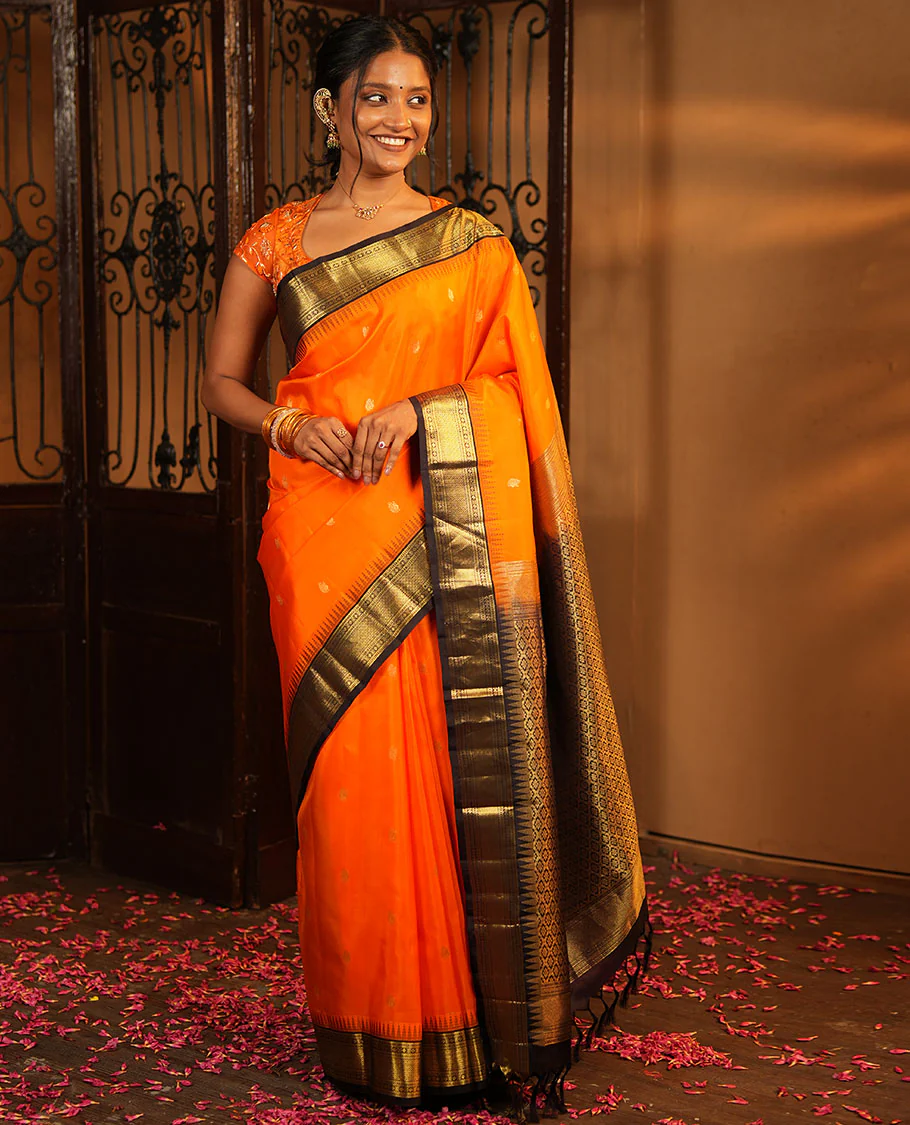 Orange Vasundhara Silk Saree, Artfully Woven with Mayil Buttas All Over Its Body, Complemented by Contrast Border Featuring Thazampoo Rekku, Muthu, Lavangam, and Mayil Kann Designs, a Grand Pallu of Jaal Designs, and Paired with a Contrast Blouse - Image 4