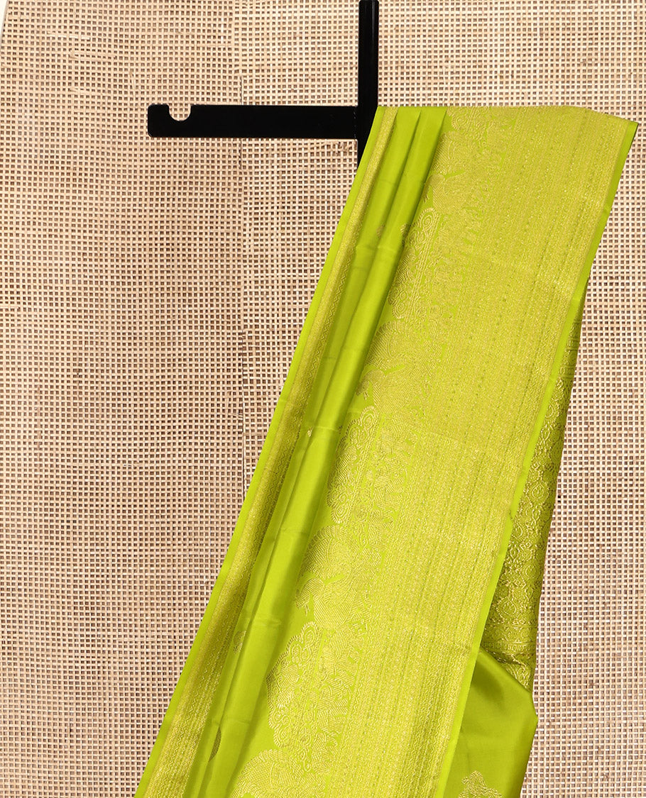 Parrot Green Kanchipuram Silk Saree, Gleamed Up with Zari Buttas All Over Its Body, Highlighted by a Zari Border of Mayil, Yaanai, and Neli Designs, Intricately Designed Pallu, and Paired with a Matching Blouse - Image 3