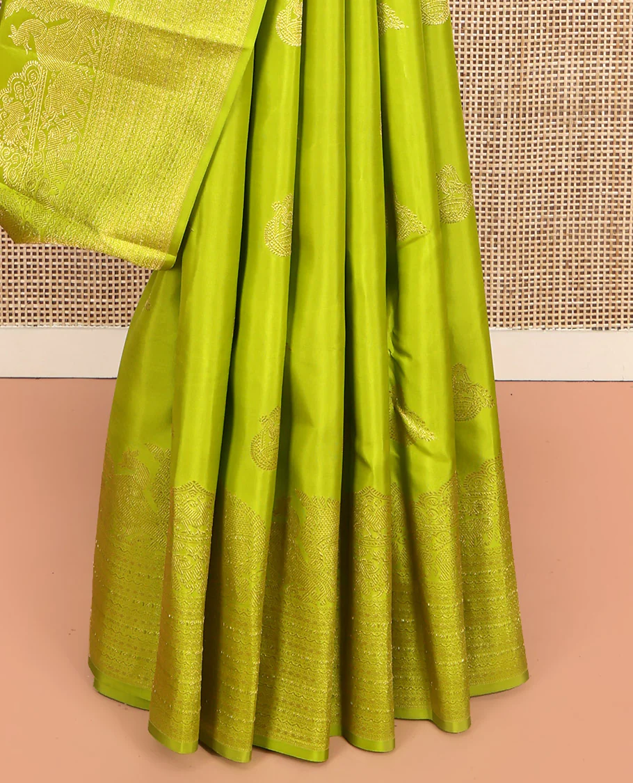 Parrot Green Kanchipuram Silk Saree, Gleamed Up with Zari Buttas All Over Its Body, Highlighted by a Zari Border of Mayil, Yaanai, and Neli Designs, Intricately Designed Pallu, and Paired with a Matching Blouse - Image 4