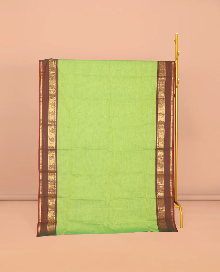 Parrot Green Plain Chettinad Cotton Saree, Complemented by Contrast Traditional Zari Design Rettai Pettu Border of Paisleys, Striped Pallu, and Paired with Matching Blouse