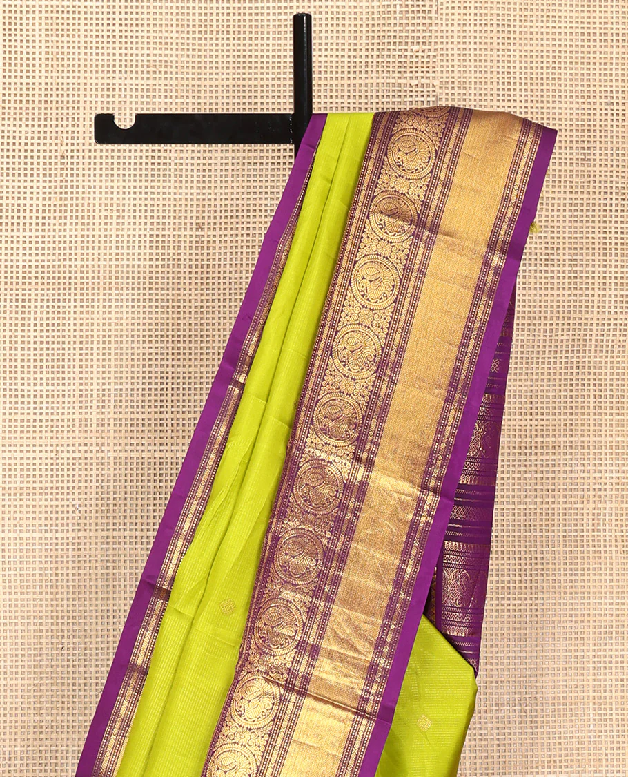 Parrot Green Vasundhara Silk Saree, Enriched with Sparse Stripes and Zari Buttas, Complemented by a Contrast Border of Thilakam, Banaras, Muthu, and Round Mayil Designs, Pallu Steeped with Traditional Designs, and Paired with a Contrast Blouse - Image 8