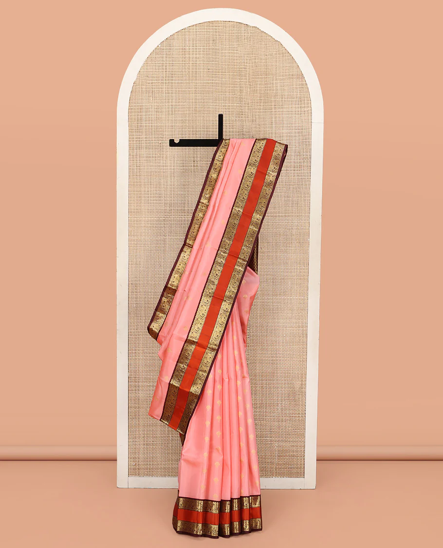 Pink Vasundhara Silk Saree, Sparsely Sparkled with Zari Buttas All Over Its Body, Complemented by a Contrast Rettai Pettu Border of Rekku, Muthu, and Yaanai Designs, Grand Geometric Pallu, and Paired with a Contrast Blouse