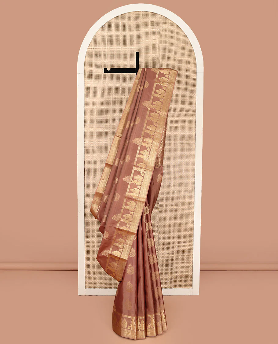 Pinkish Brown Vasundhara Silk Saree, Elevated with Zari Buttas All Over Its Body, Highlighted by Zari Border of Rekku, Muthu, Vangi, and Bride-Groom Suyamvaram Designs, Pallu of Zari Designs, and Paired with a Matching Blouse