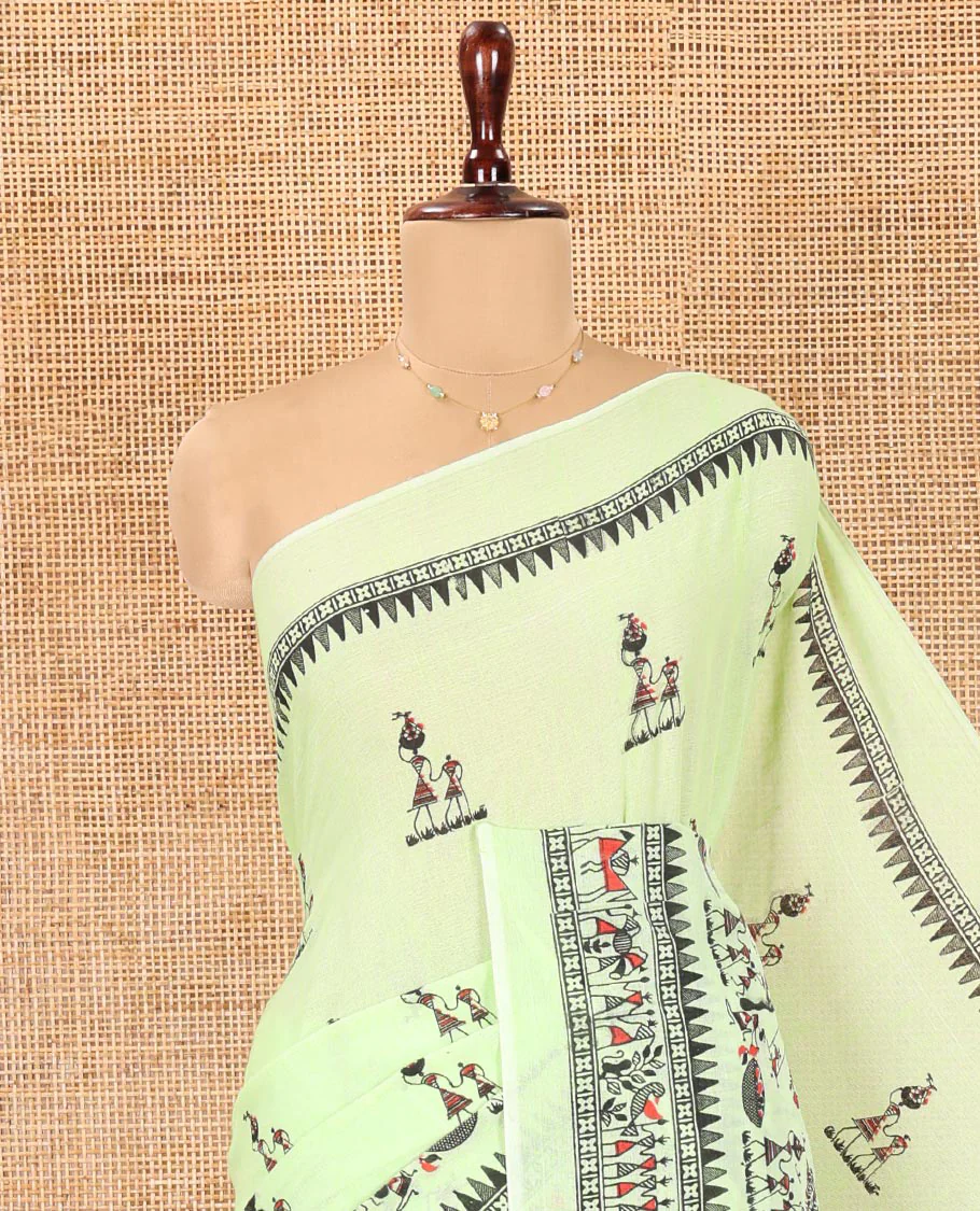 Pista Green Khadi Mul Cotton Saree, Artfully Printed with Warli Motifs All Over Its Body, Highlighted by a Self-Border of Warli Print, Pallu of Warli Print, and Paired with a Matching Blouse - Image 2
