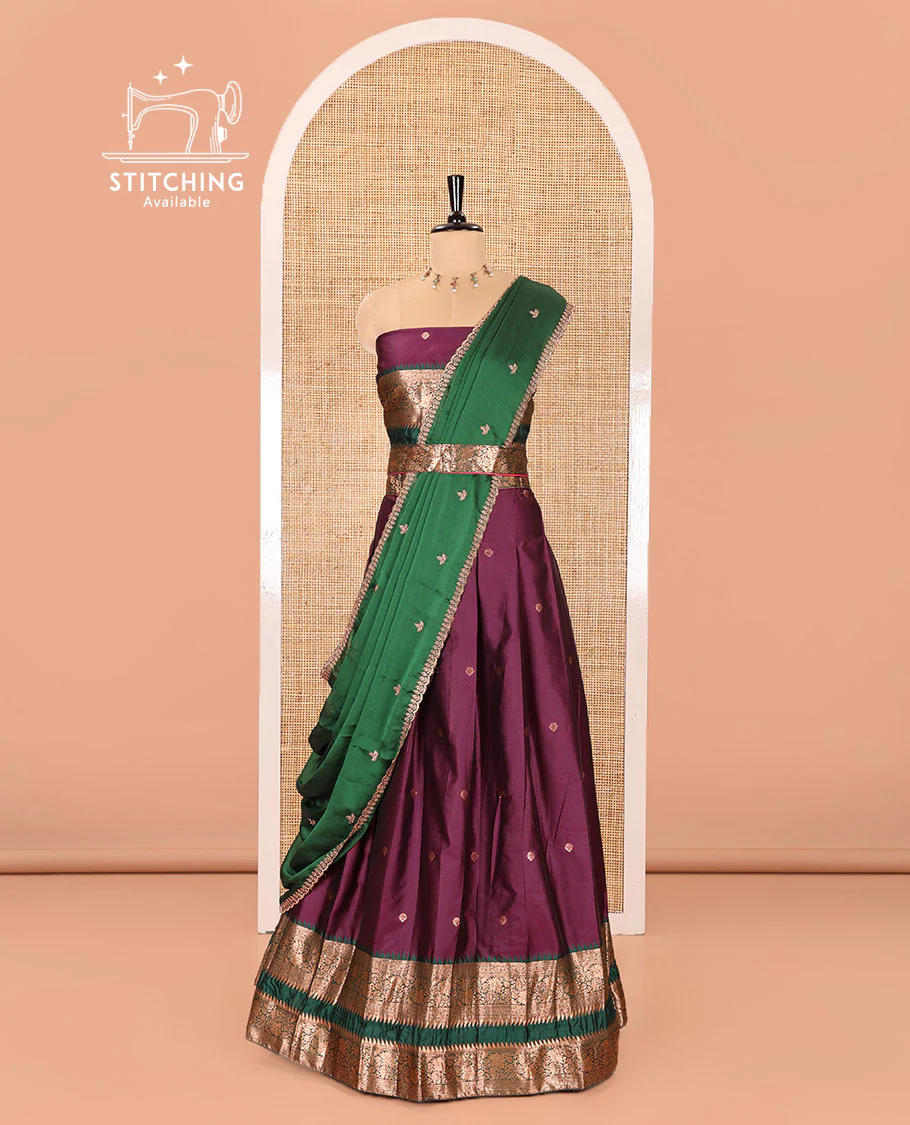 Purple-Green Semi-Banarasi Half-Saree Featuring Zari Buttas on Its Skirt, Complemented by a Contrast Traditional Zari Temple Rettai Pettu Border, Paired with a Matching Blouse, and a Satin Georgette Embroidered Scallop Dhavani