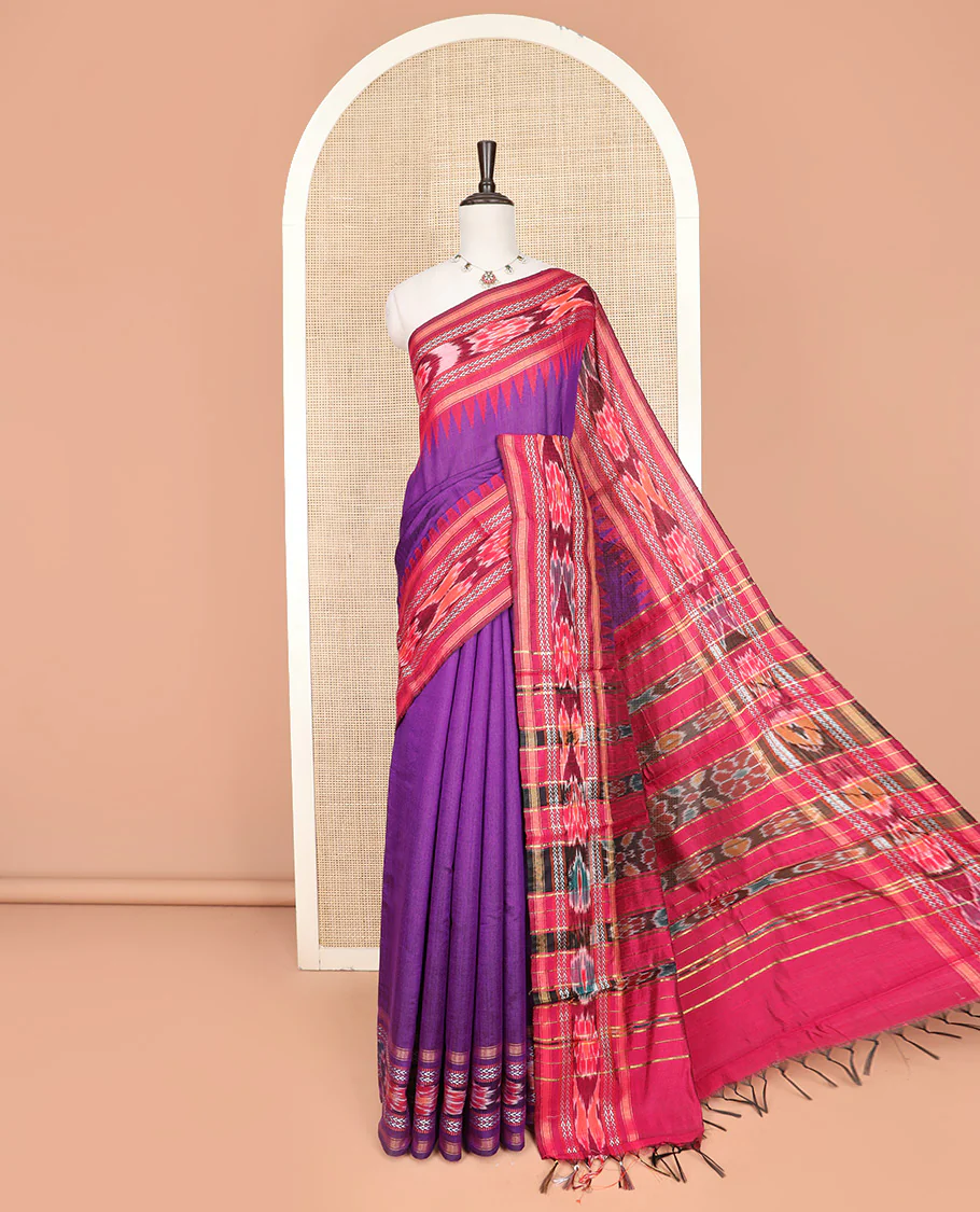 Purple Plain Dupion Silk Saree, Spotlighted with a Contrast Temple Border of Geometric Patterns and Ikkat Weave, Pallu Depicting Floral Ikkat Designs, and Paired with a Contrast Blouse