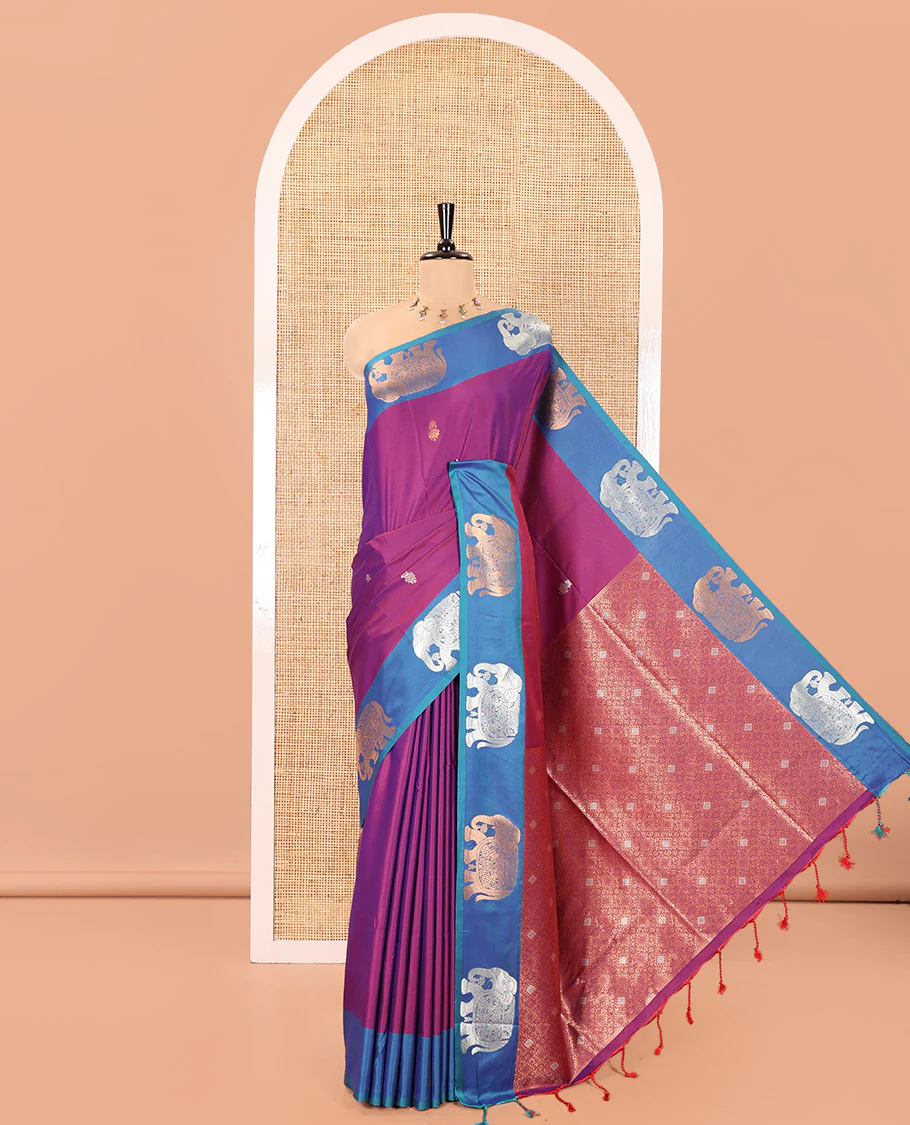 Purple Soft Silk Saree, Accentuated With Zari Buttas All Over Its Body, Complemented by Captivating Contrast Border of Elephant Motifs, Grandly Decked Up Pallu, and Paired with a Contrast Blouse