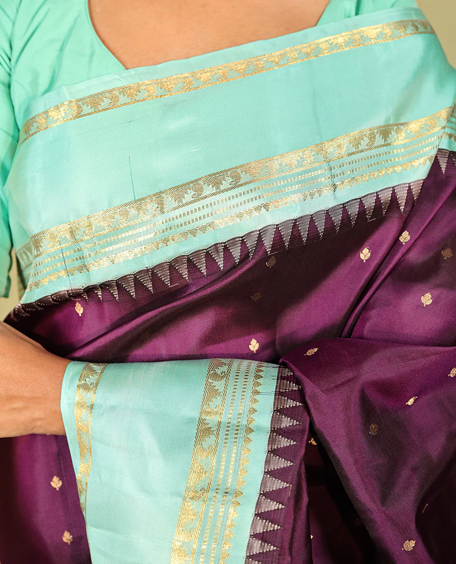 Purple Vasundhara Silk Saree, Spotlighted With Zari Buttas All Across Its Body, Complemented by Captivating Contrast Rettai Pettu Border of Thazampoo Rekku, Muthu, And Manga Designs, a Gleaming Zari Design Pallu, And Paired With a Contrast Blouse - Image 2