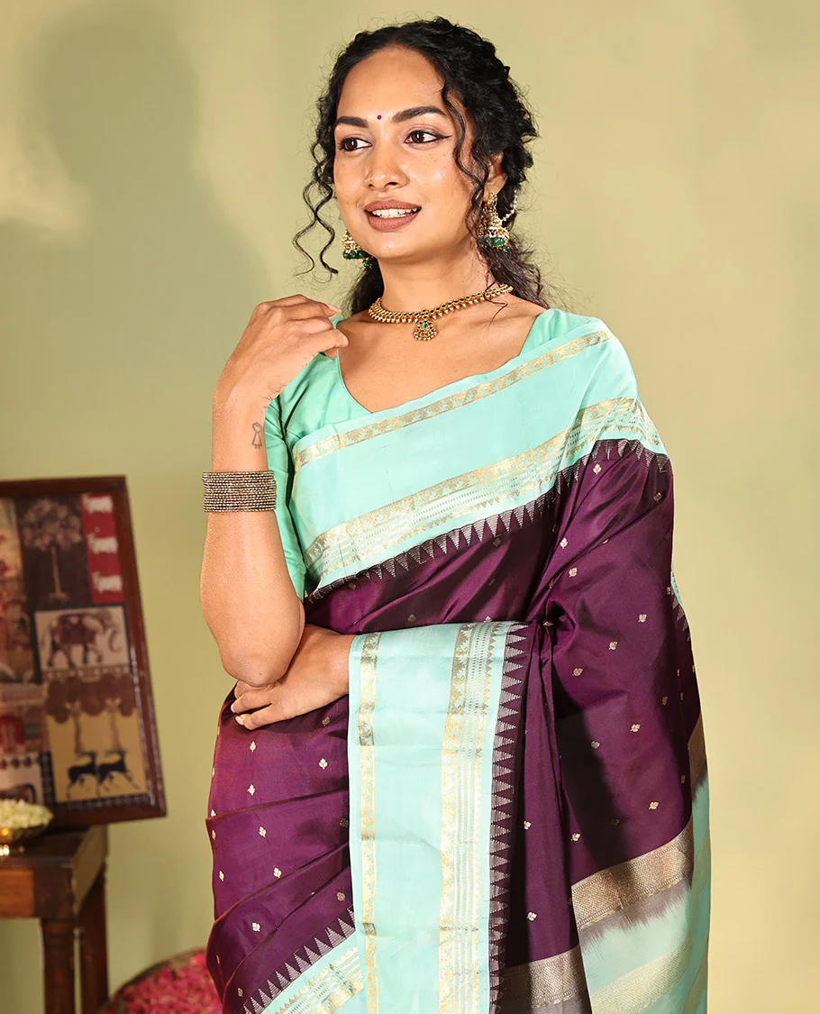 Purple Vasundhara Silk Saree, Spotlighted With Zari Buttas All Across Its Body, Complemented by Captivating Contrast Rettai Pettu Border of Thazampoo Rekku, Muthu, And Manga Designs, a Gleaming Zari Design Pallu, And Paired With a Contrast Blouse - Image 4
