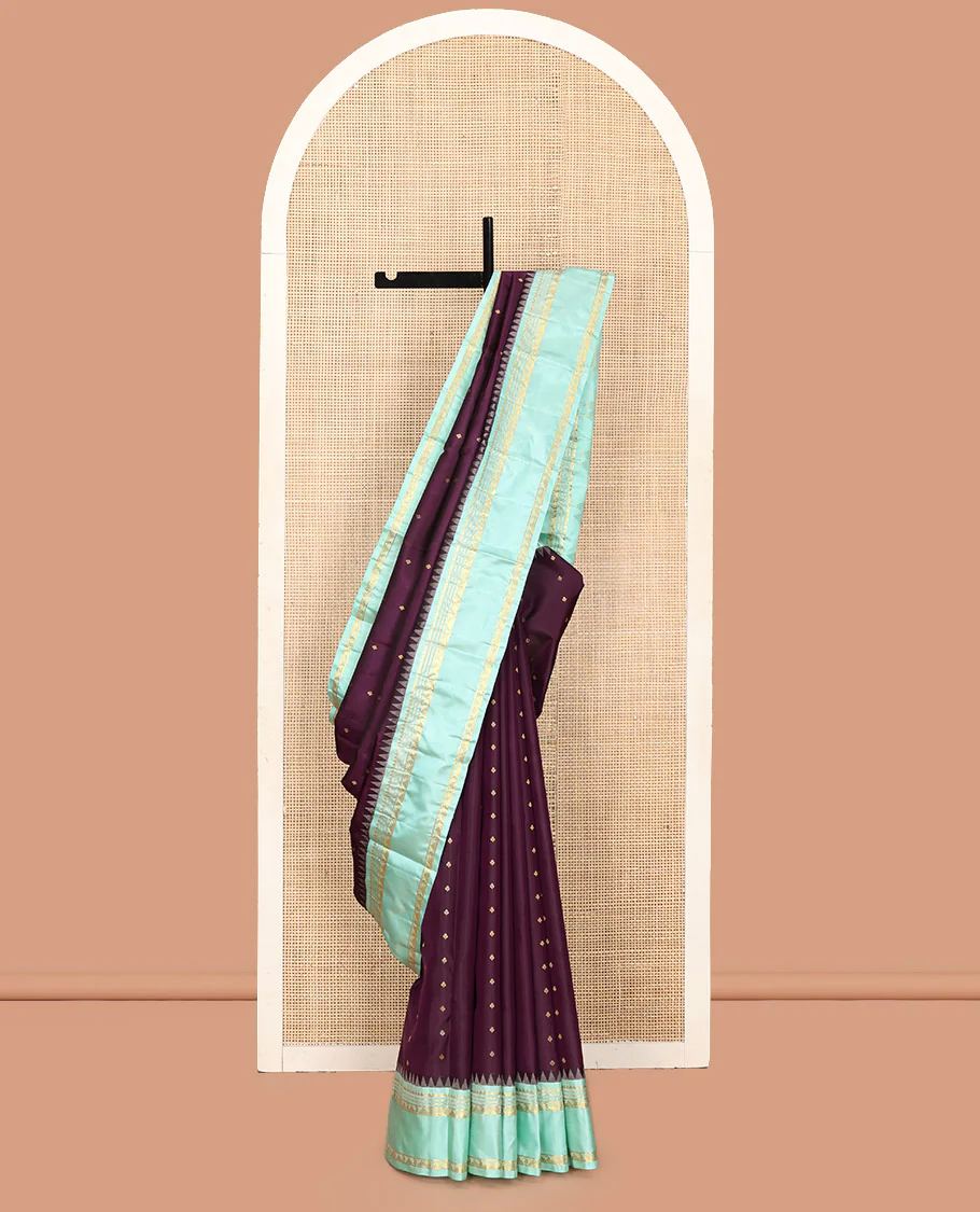 Purple Vasundhara Silk Saree, Spotlighted With Zari Buttas All Across Its Body, Complemented by Captivating Contrast Rettai Pettu Border of Thazampoo Rekku, Muthu, And Manga Designs, a Gleaming Zari Design Pallu, And Paired With a Contrast Blouse - Image 8