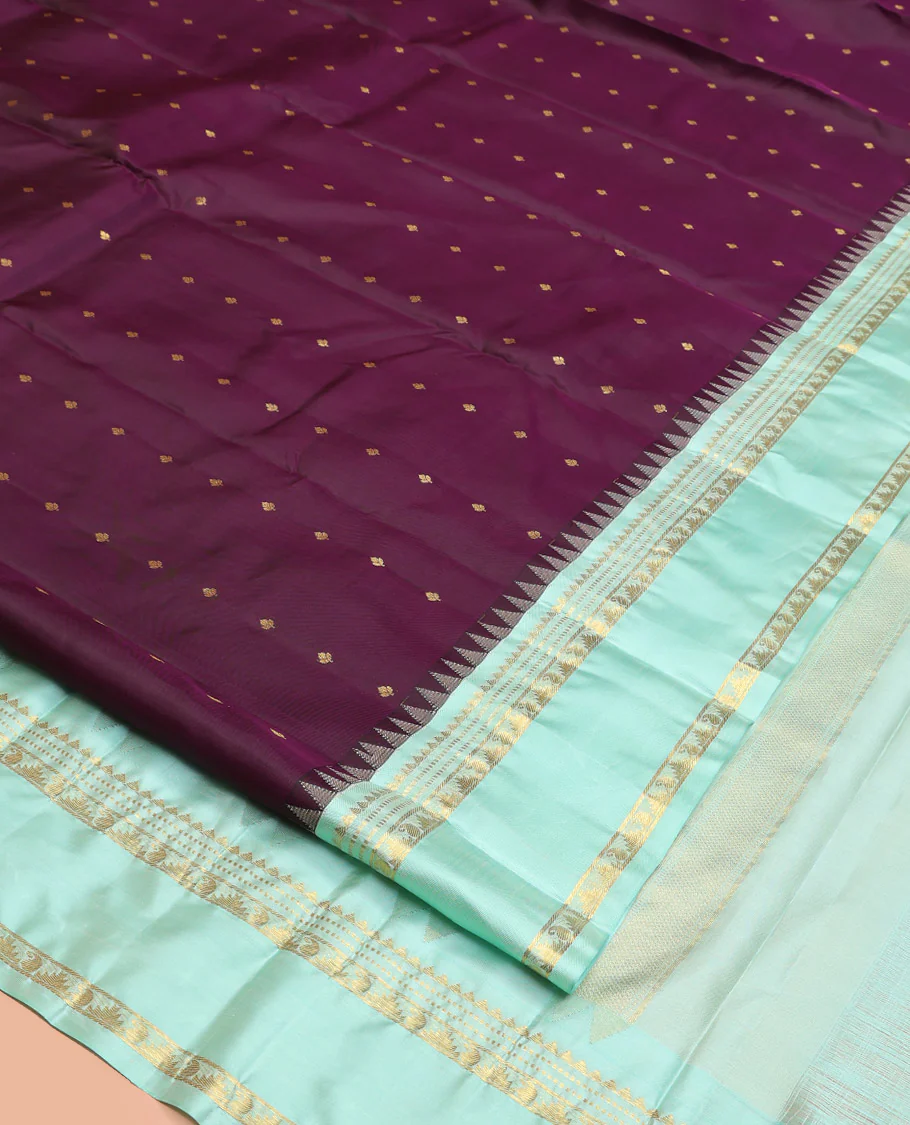 Purple Vasundhara Silk Saree, Spotlighted With Zari Buttas All Across Its Body, Complemented by Captivating Contrast Rettai Pettu Border of Thazampoo Rekku, Muthu, And Manga Designs, a Gleaming Zari Design Pallu, And Paired With a Contrast Blouse - Image 9