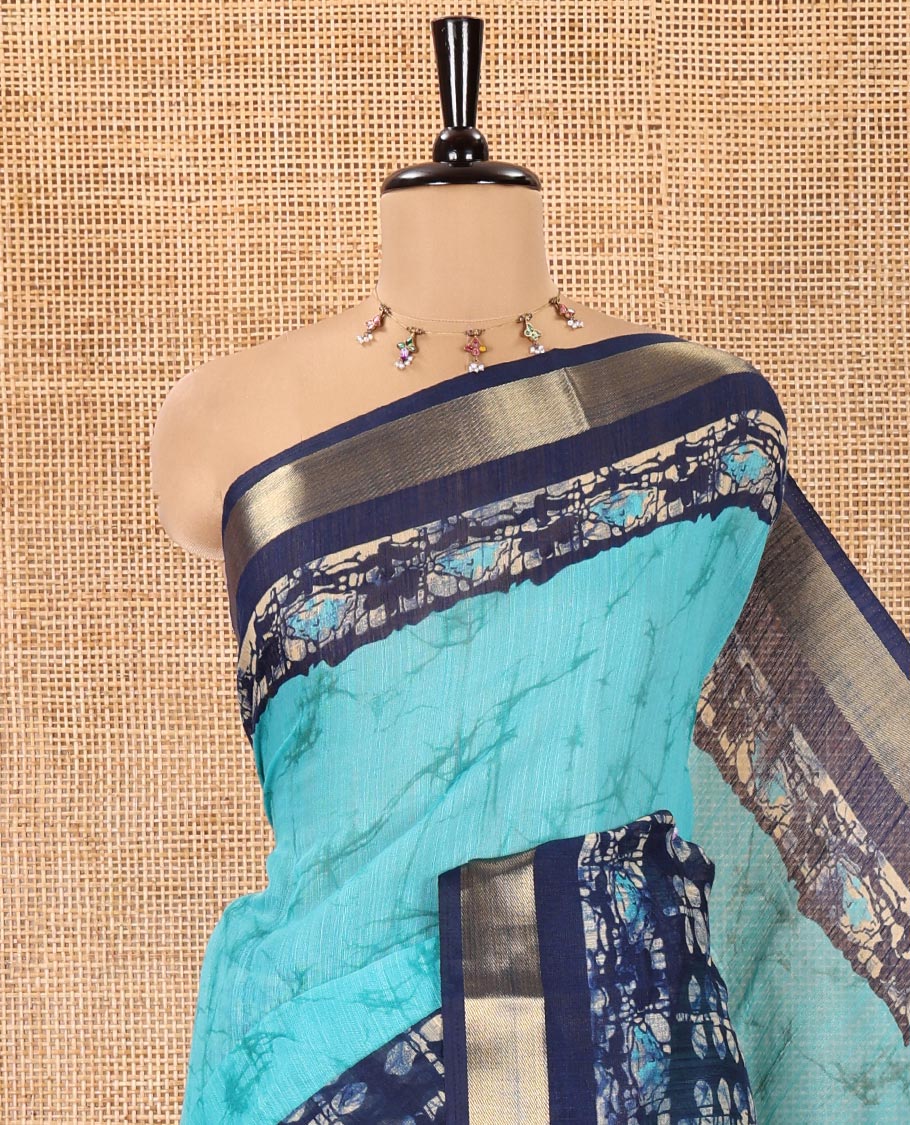Rama Green Linen Cotton Saree, Adorned with Shibori Printed All Over Its Body, Complemented by a Contrast Batik Printed Zari Border, Floral Printed Pallu, and Paired with a Contrast Blouse - Image 2