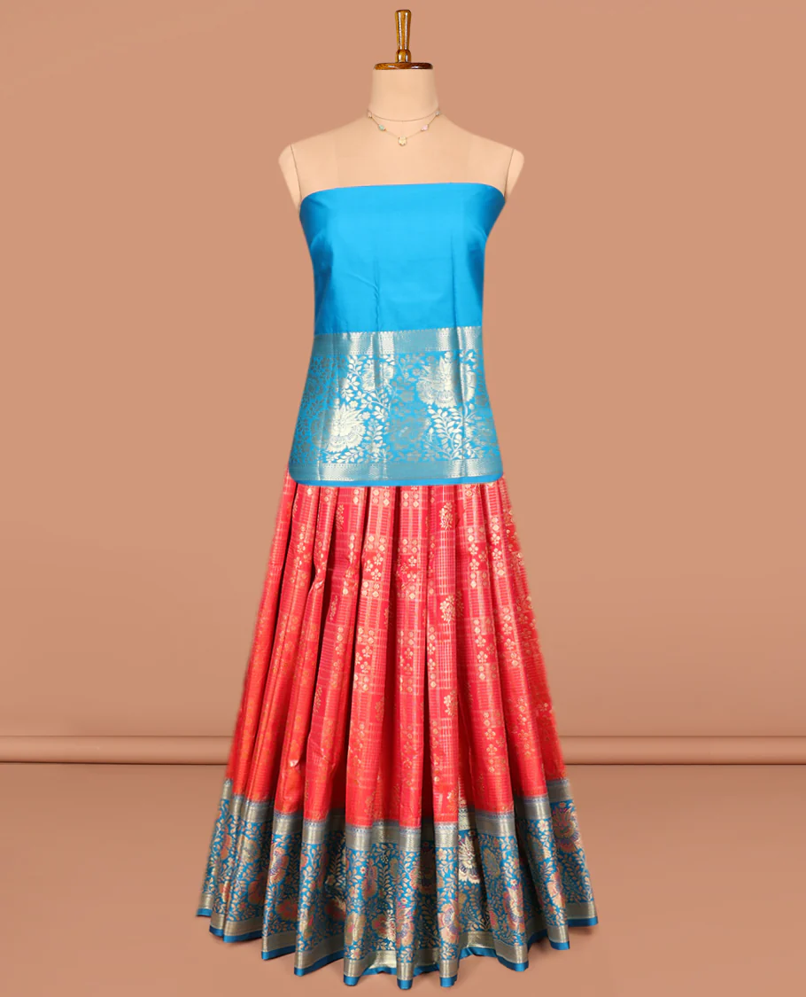 Red Art Silk Pavadai Material Set, Delicately Woven with Zari Buttas and Checks on Its Skirt, Complemented by a Contrast Floral Zari Design Border, and Paired with a Contrast Blouse