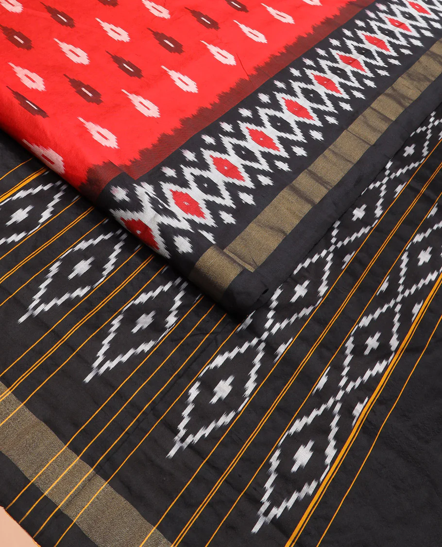 Red Ikkat Silk Saree Brightened with Ikkat Buttas, Complemented by a Contrast Ikkat Design Border, a Hazily Woven Pallu of Diamond Patterns, and a Contrast Blouse