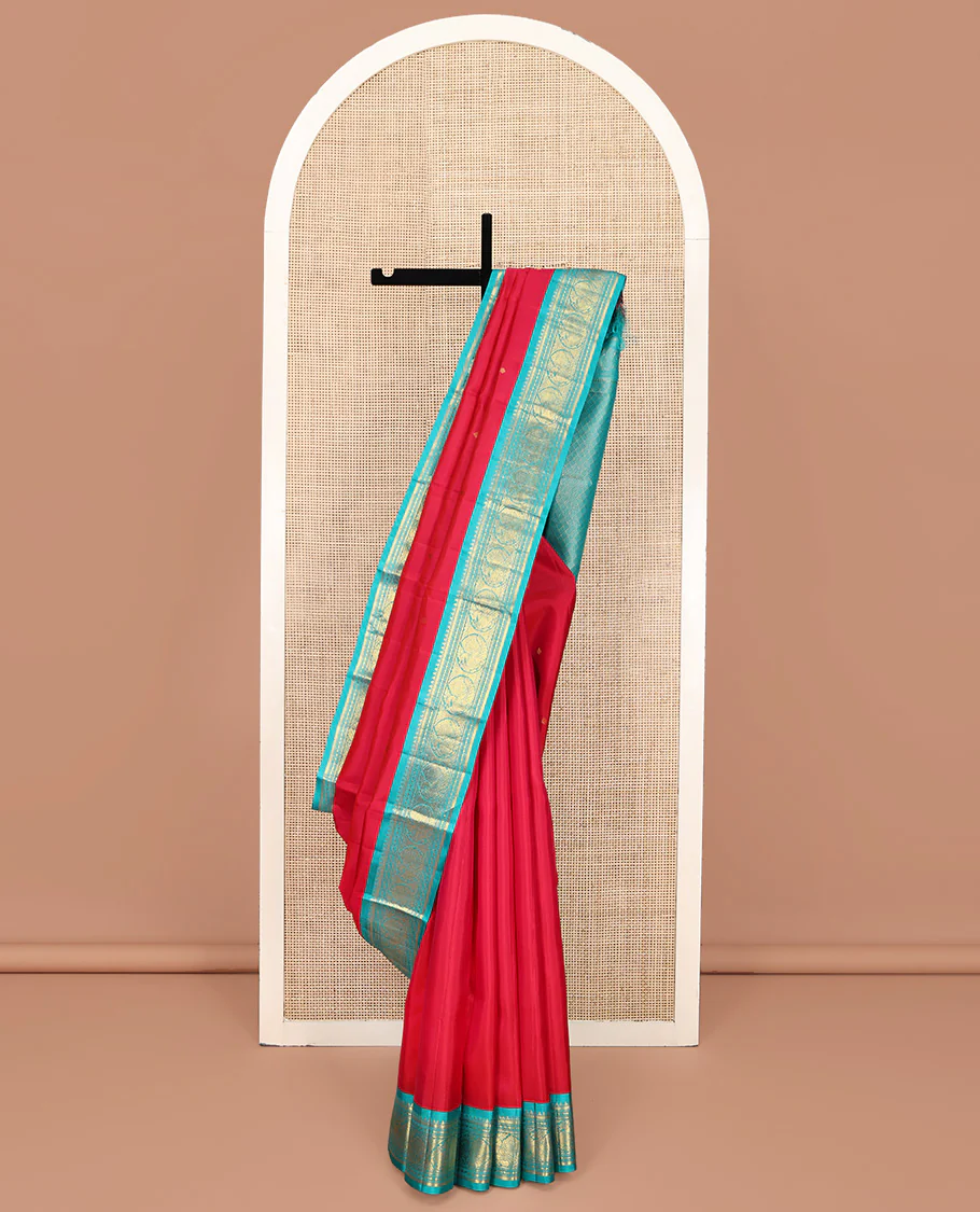 Red Vasundhara Silk Saree, Sparsely Woven with Zari Buttas All Over Its Body, Complemented by a Contrast Border of Rekku, Banaras, Diamond, and Round Mayil Designs, Grand Jaal-Patterned Pallu, and Paired with a Contrast Blouse