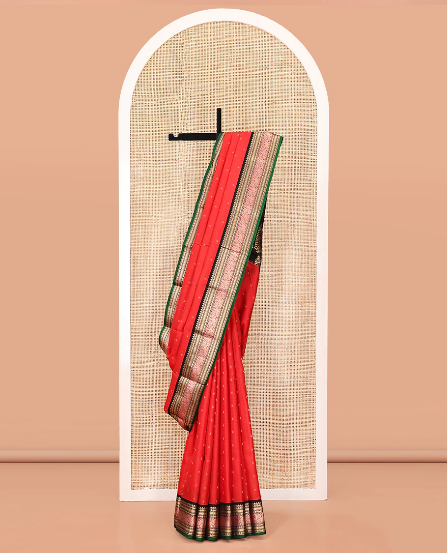 Red Vasundhara Silk Saree, Sparsely Woven with Zari Buttas All Over Its Body, Complemented by a Contrast Border of Rekku, Muthu, Poun, Kathir, and Mayil Designs, Beautifully Bedecked Pallu, and Paired with a Contrast Blouse