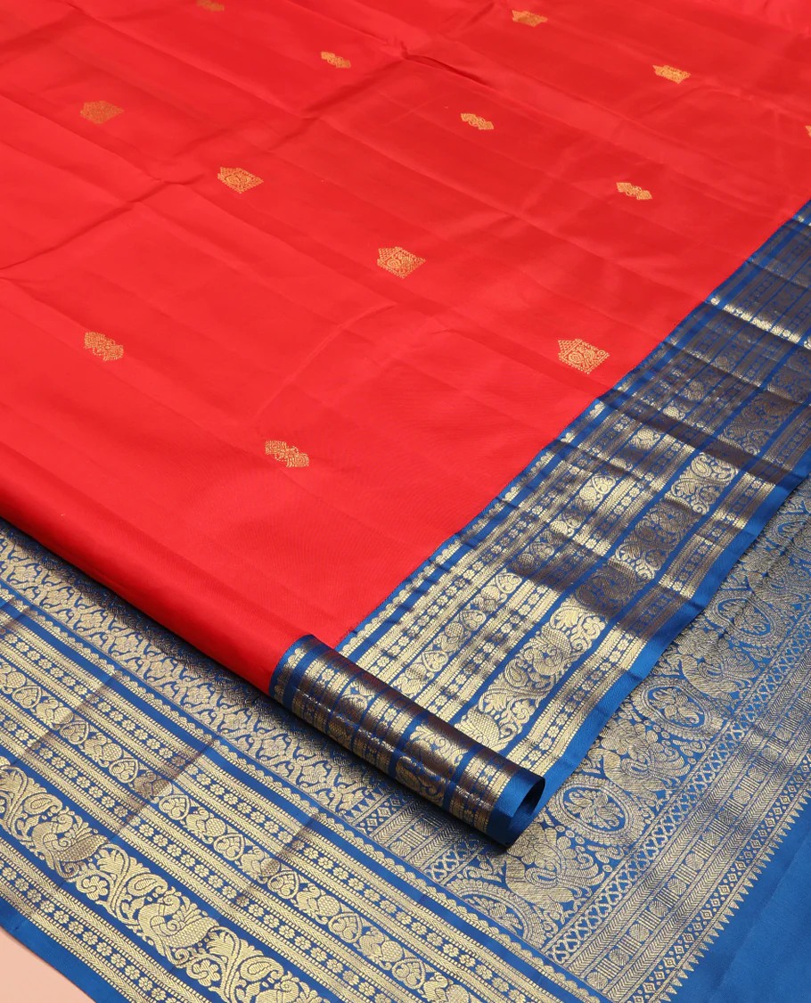 Red Vasundhara Silk Saree, Subtly Sparkled With Zari Buttas All Over Its Body, Complemented by Contrast Border of Salngai, Muthu, Kamalam, Jada Nagam, and Mayil Designs, Grand Pallu and Paired with a Contrast Blouse - Image 2