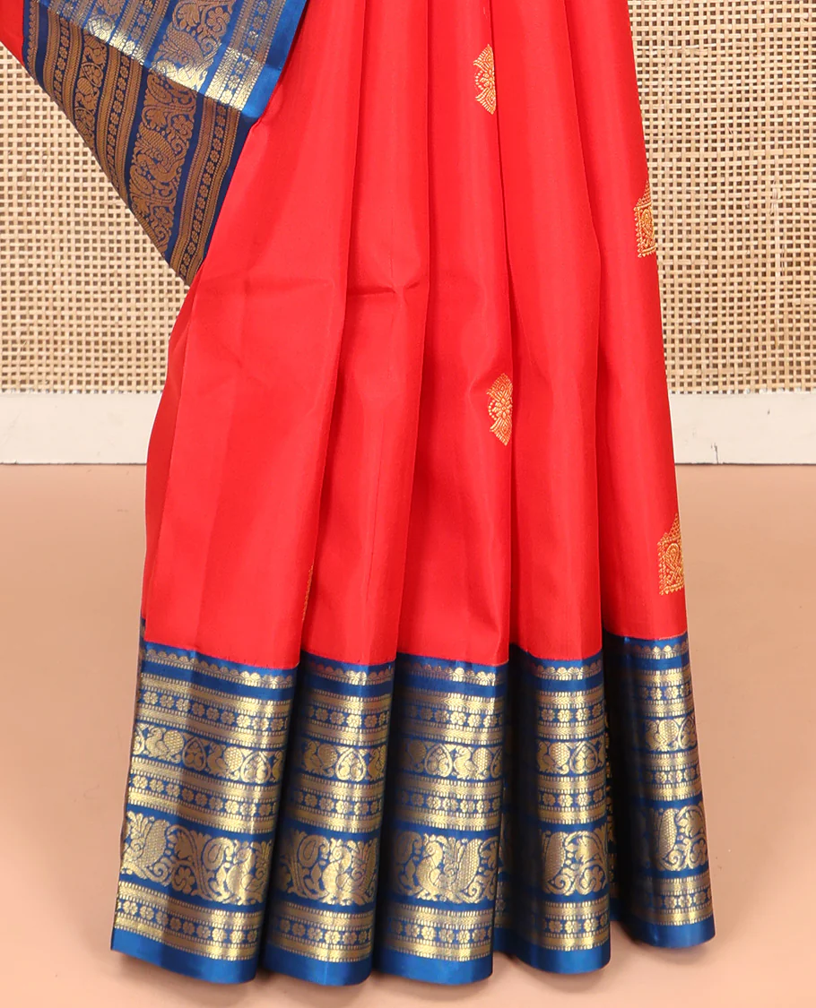 Red Vasundhara Silk Saree, Subtly Sparkled With Zari Buttas All Over Its Body, Complemented by Contrast Border of Salngai, Muthu, Kamalam, Jada Nagam, and Mayil Designs, Grand Pallu and Paired with a Contrast Blouse - Image 4