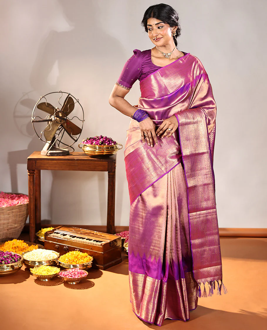 Scintillating Purple Vasundhara Lite-Silk Mix Saree, Gleamed Up with Zari on Its Body, Highlighted by Thazampoo Rekku Border of Neli, Paisa, Cross Kamalam, and Kodi Visiry Designs, a Grand Geometric-Patterned Pallu, and Paired with a Matching Blouse