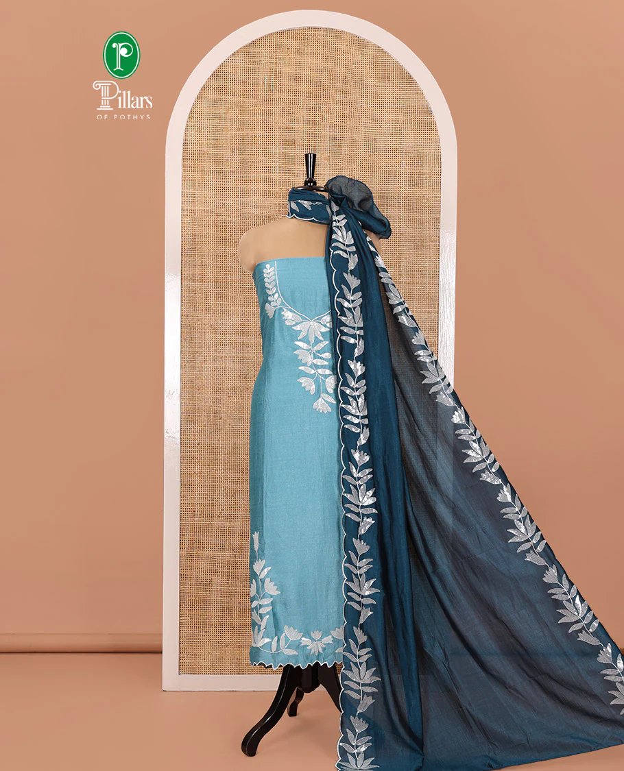 Sky Blue Material Churidar Set, Detailed with Floral Motifs Sequins-Thread Embroidered on Its Vichitra Silk Top, Comes with a Contrast Santoon Bottom, and Paired with a Vichitra Silk Floral Embroidered Scallop Dupatta