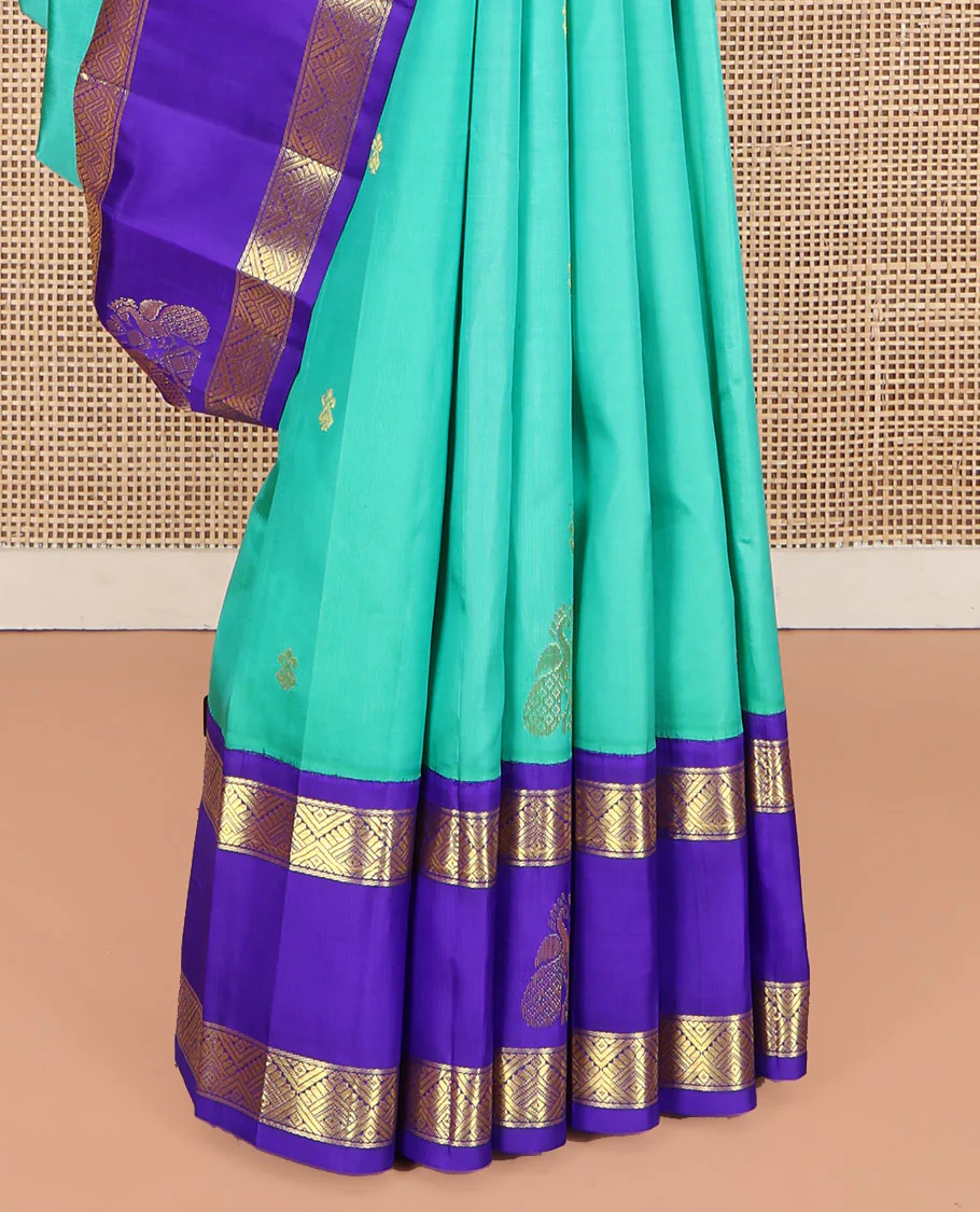 Turquoise Kanchipuram Silk Saree, Beautified with Zari Buttas on Its Body, Complemented by Contrast One-Sided Korvai Border of Diamond Designs, Pallu Steeped with Paisley and Floral Designs, and Comes Without a Blouse - Image 4