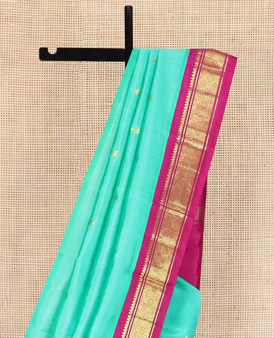 Turquoise Kanchipuram Silk Saree Bedecked with Zari Buttas All Over Its Body, Complemented by a Contrast One-Sided Korvai Border of Thilakam Mokku, Banaras, and Jaal Designs, Pallu of Zari Designs, and Comes Without a Blouse - Image 3