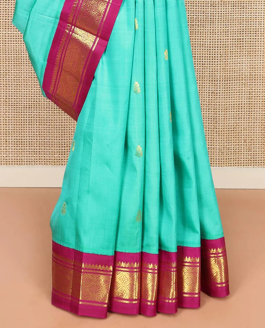 Turquoise Kanchipuram Silk Saree Bedecked with Zari Buttas All Over Its Body, Complemented by a Contrast One-Sided Korvai Border of Thilakam Mokku, Banaras, and Jaal Designs, Pallu of Zari Designs, and Comes Without a Blouse - Image 4