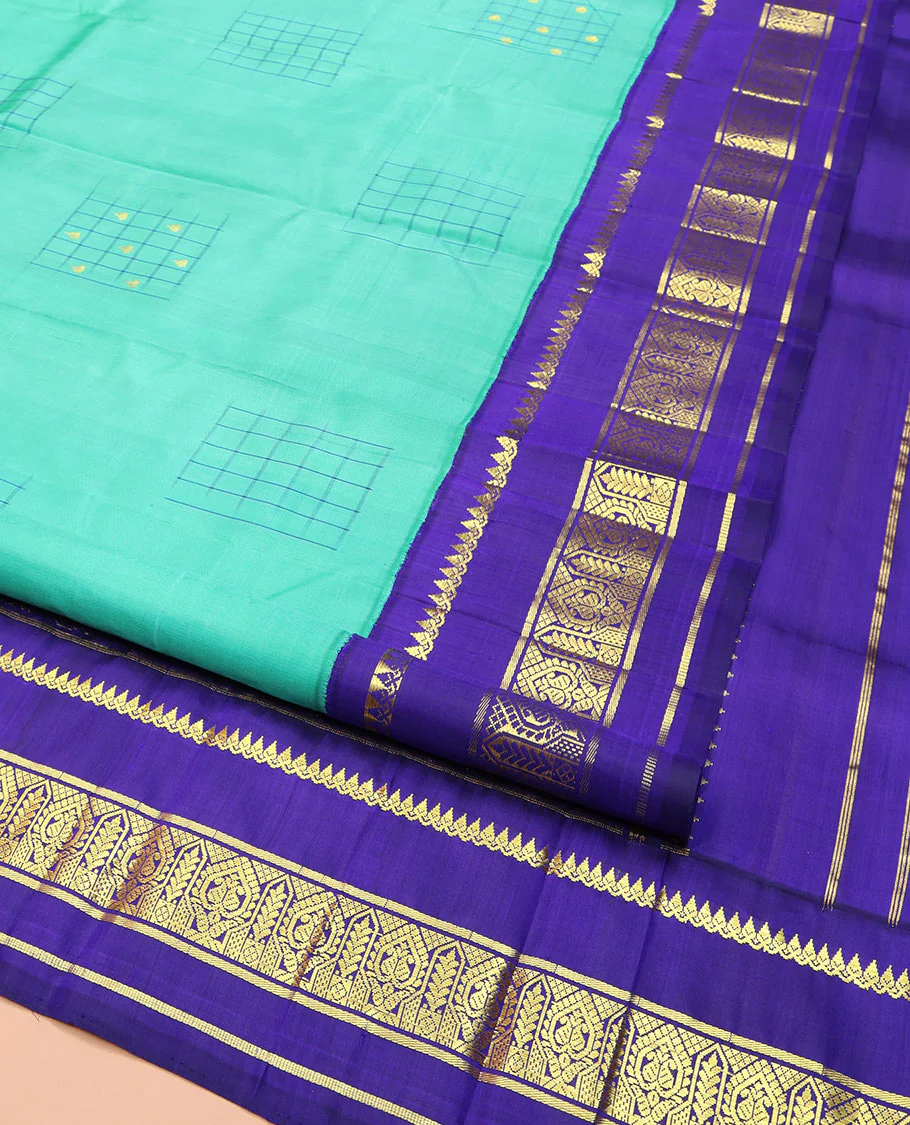 Turquoise Kanchipuram Silk Saree, Subtly Sparkled with Checked Buttas on Its Body, Complemented by a Contrast One-Sided Korvai Border of Thilakam Mokku, and Manga Designs, Pallu of Peacock Chariot Designs, and Comes Without a Blouse - Image 2