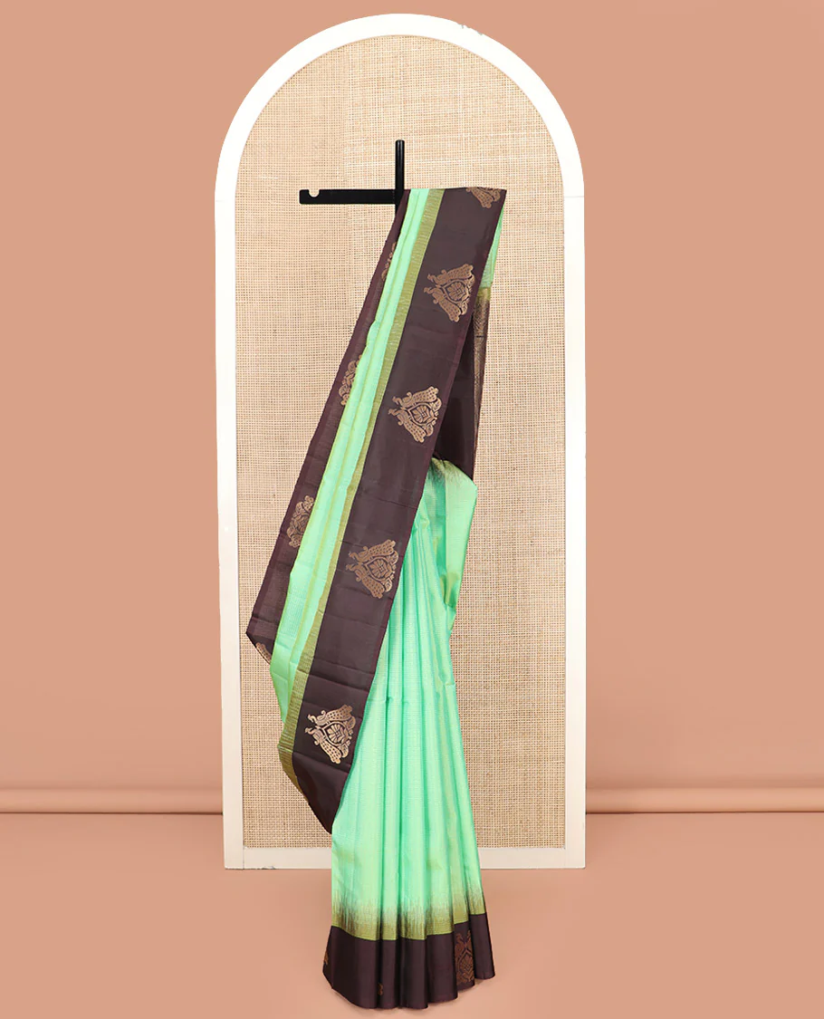 Turquoise Kanchipuram Silk Saree, Subtly Sparkled with Zari Checks on Its Body, Complemented by a Contrast Border of Mayil Designs, Pallu Beautified with Jaal Design, and Paired with a Contrast Blouse