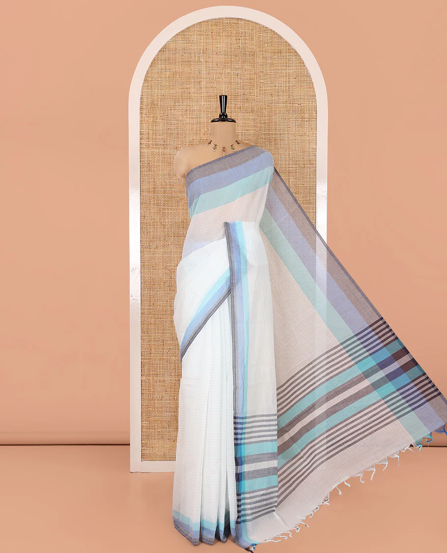 White and Blue Chettinad Cotton Saree, Subtly Sparkled with Stripes All Over Its Body, Complemented by a Contrast Tri-Colored Striped Border, Pallu of Stripes, and Has No Blouse