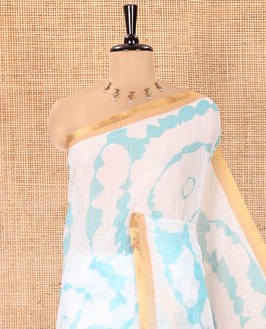 White-Green Linen Cotton Saree, Elevated with Shibori-Printed Body, Highlighted by Piping Border, Floral Printed Pallu, and a Contrast Blouse - Image 2