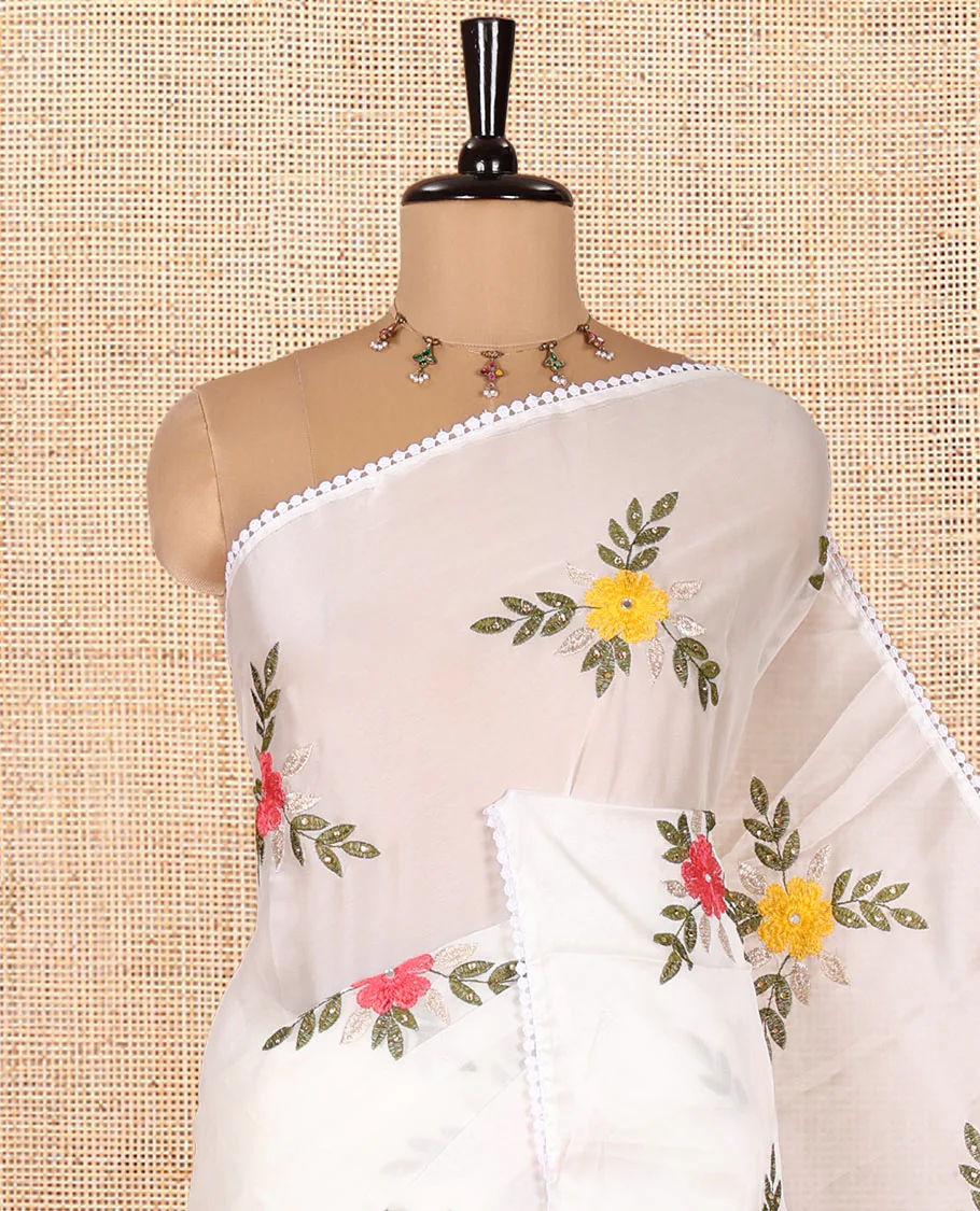 White Rangoli Chiffon Saree, Artfully Embroidered with Floral Motifs in Thread and Stone Work On Its Body, Subtly Sparkled with Lace Border, a Self-Pallu, and Paired with a Contrast Floral Embroidered Blouse - Image 2