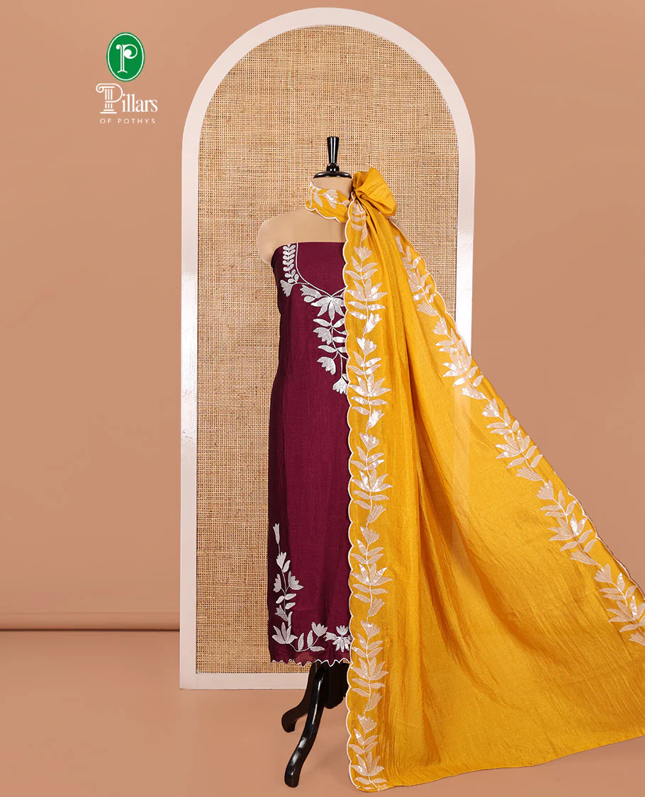 Wine Material Churidar Set, Detailed with Floral Motifs Sequins-Thread Embroidered on Its Vichitra Silk Top, Comes with a Contrast Santoon Bottom, and Paired with a Vichitra Silk Floral Embroidered Scallop Dupatta