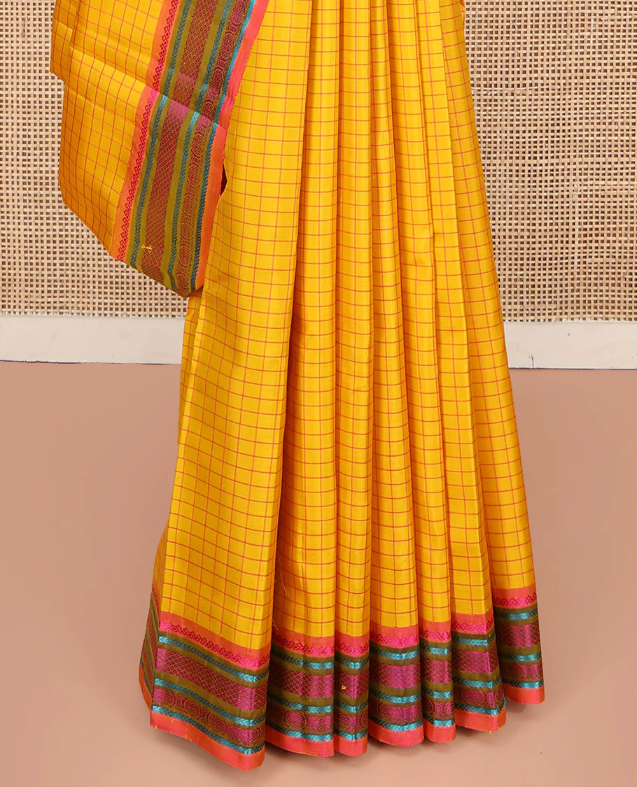 Yellow kanchipuram silk saree, subtly sparkled with checked design on its body, complemented by a contrast border of salngai, kathir, mayil kann, kathir, and rudraksham designs, a subtly striped pallu, and paired with a contrast blouse - Image 4