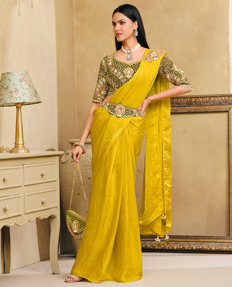 Yellow Plain Party Wear Designer Saree, Complemented with a Contrast Sweetheart Neck Heavy Embroidered Elbow Sleeve Readymade Blouse, Detachable Embroidered Belt, and a Free Embroidered Flap Sling Bag