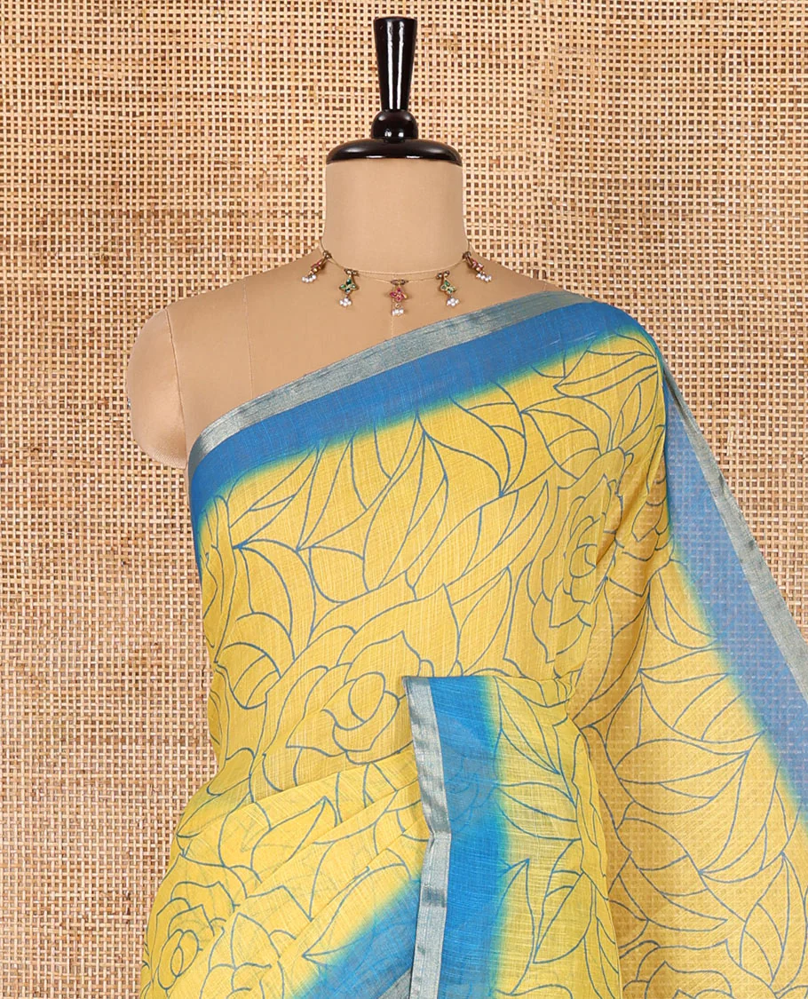 Yellow rose floral printed linen cotton saree, contrast piping border, rose floral printed pallu, and a contrast leaf motifs printed blouse - Image 2